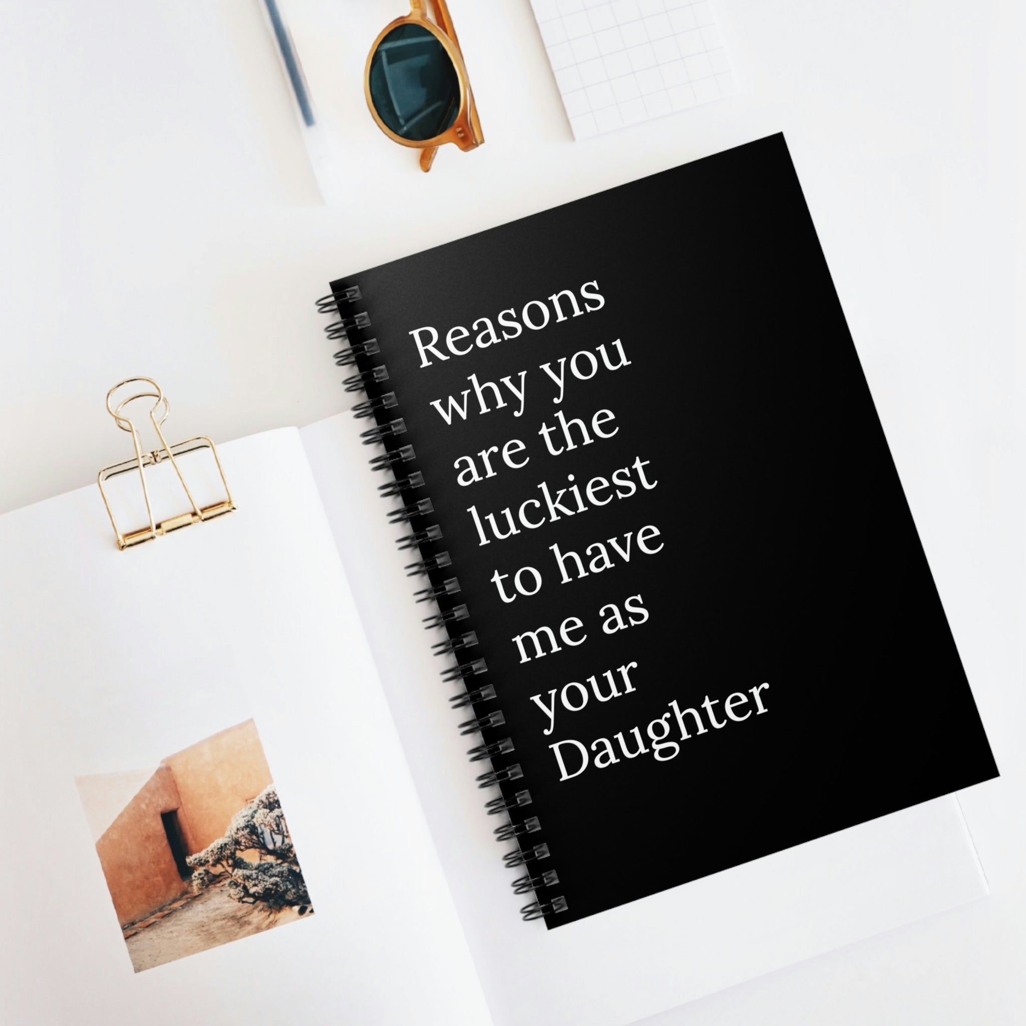 Spiral notebook with a colorful cover saying 'Reasons Why You Are The Luckiest To Have Me As Your Daughter', featuring ruled line pages.