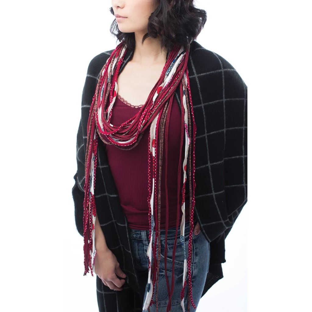 Red Essential Fiona scarf featuring maroon dotted, heathered, and white floral prints, showcasing its unique fringe design.