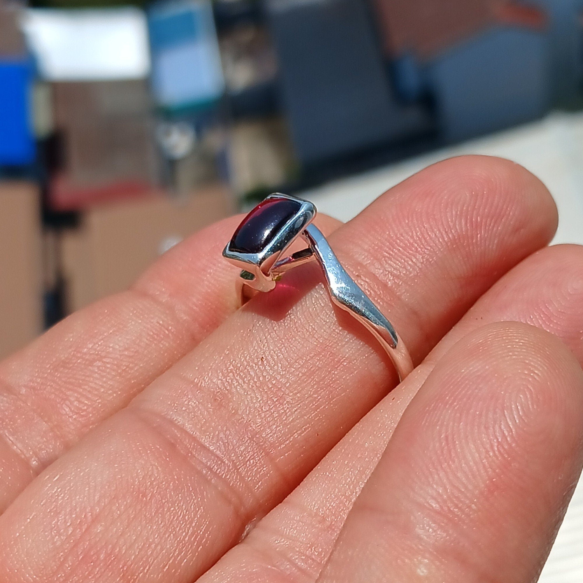 Elegant Red Garnet Ring in sterling silver with a rectangle-shaped cabochon, showcasing a polished band and minimalist design.