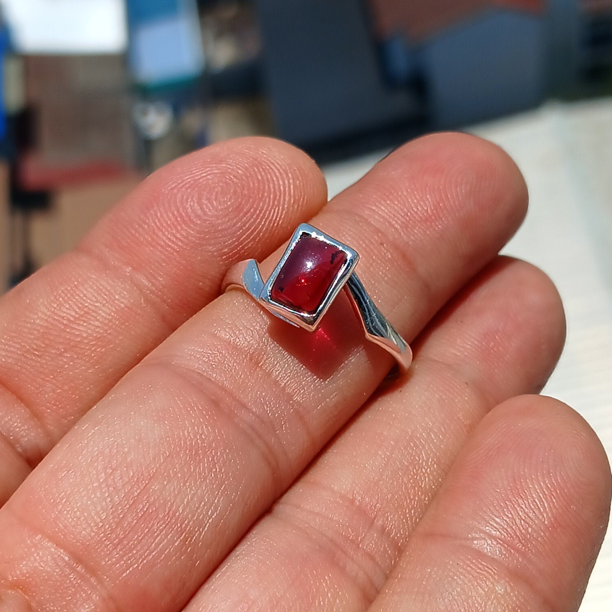 Elegant Red Garnet Ring in sterling silver with a rectangle-shaped cabochon, showcasing a polished band and minimalist design.