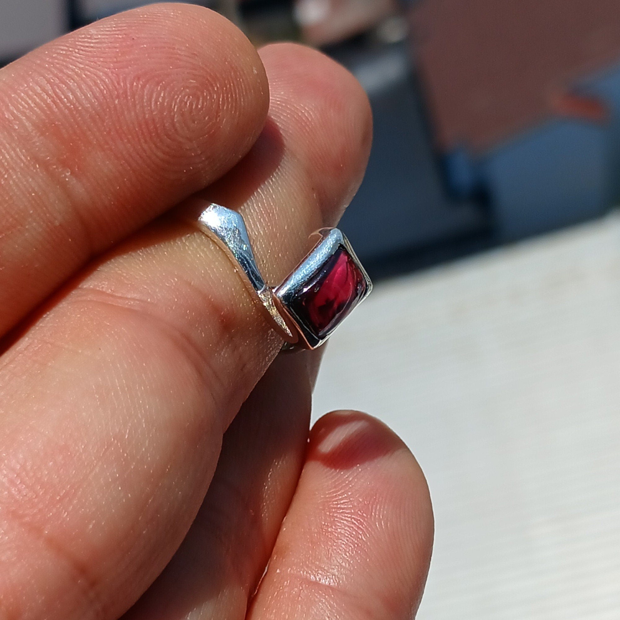 Elegant Red Garnet Ring in sterling silver with a rectangle-shaped cabochon, showcasing a polished band and minimalist design.