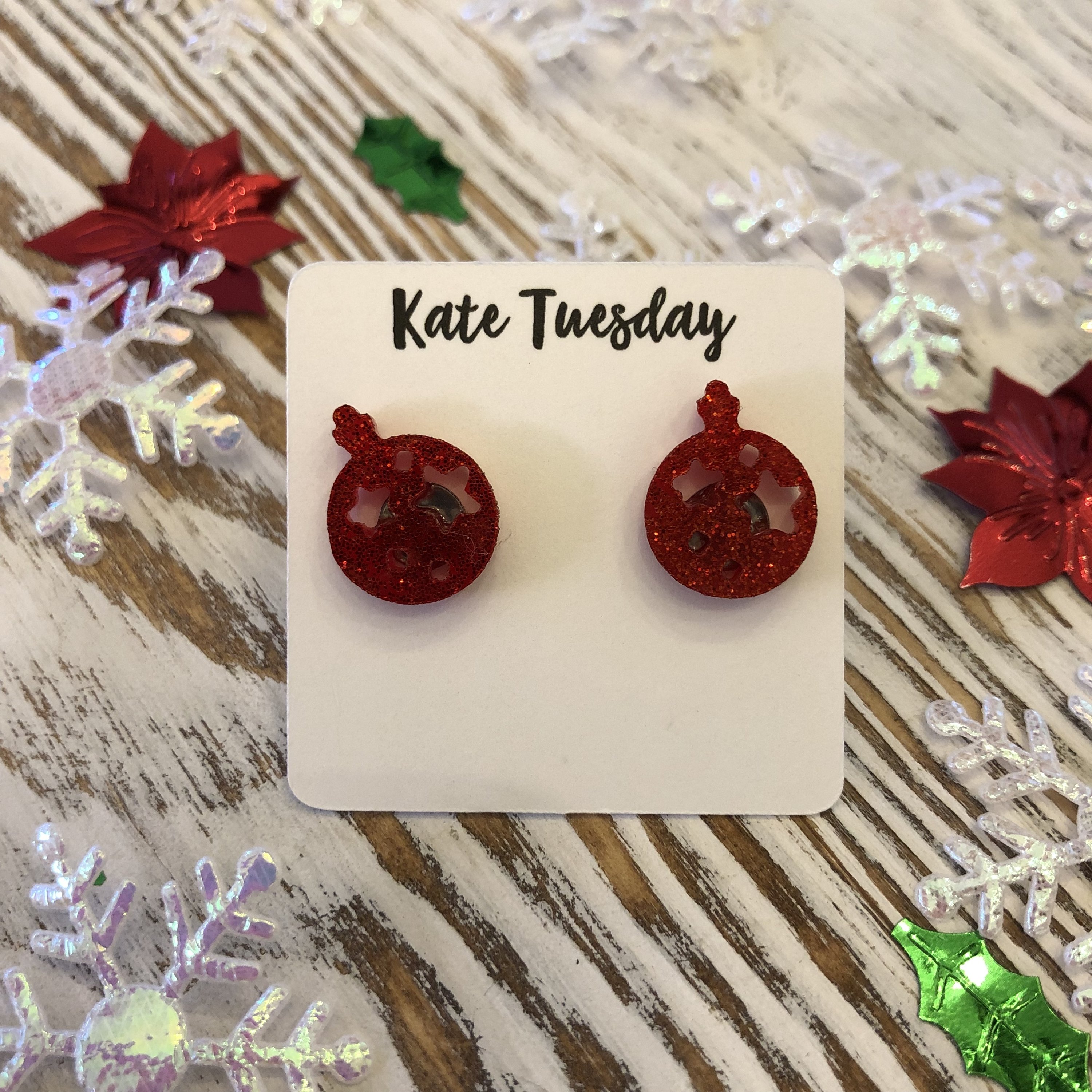 A pair of red glitter ornament acrylic stud earrings, sparkling with festive charm, perfect for holiday celebrations.