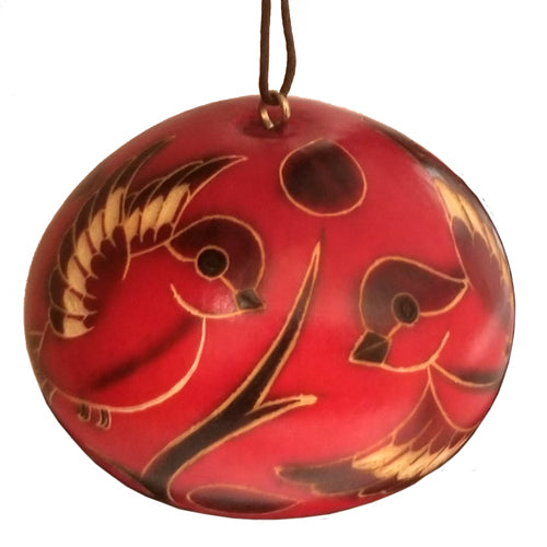 A beautifully handcrafted red gourd ornament featuring intricately etched birds, symbolizing peace and tradition, perfect for home decor.