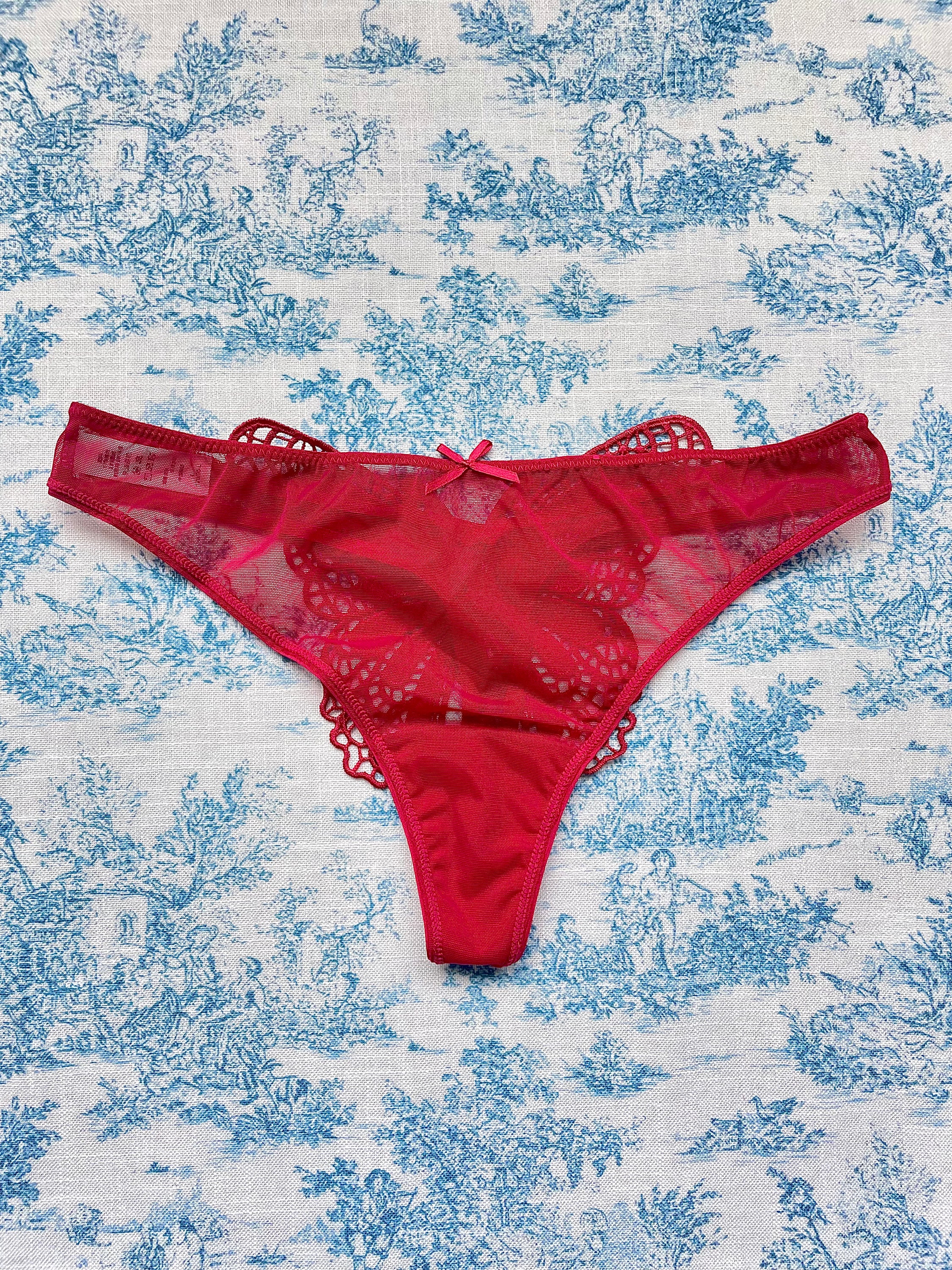 Red mesh butterfly panty featuring a playful butterfly design on the back and comfortable cotton lining.