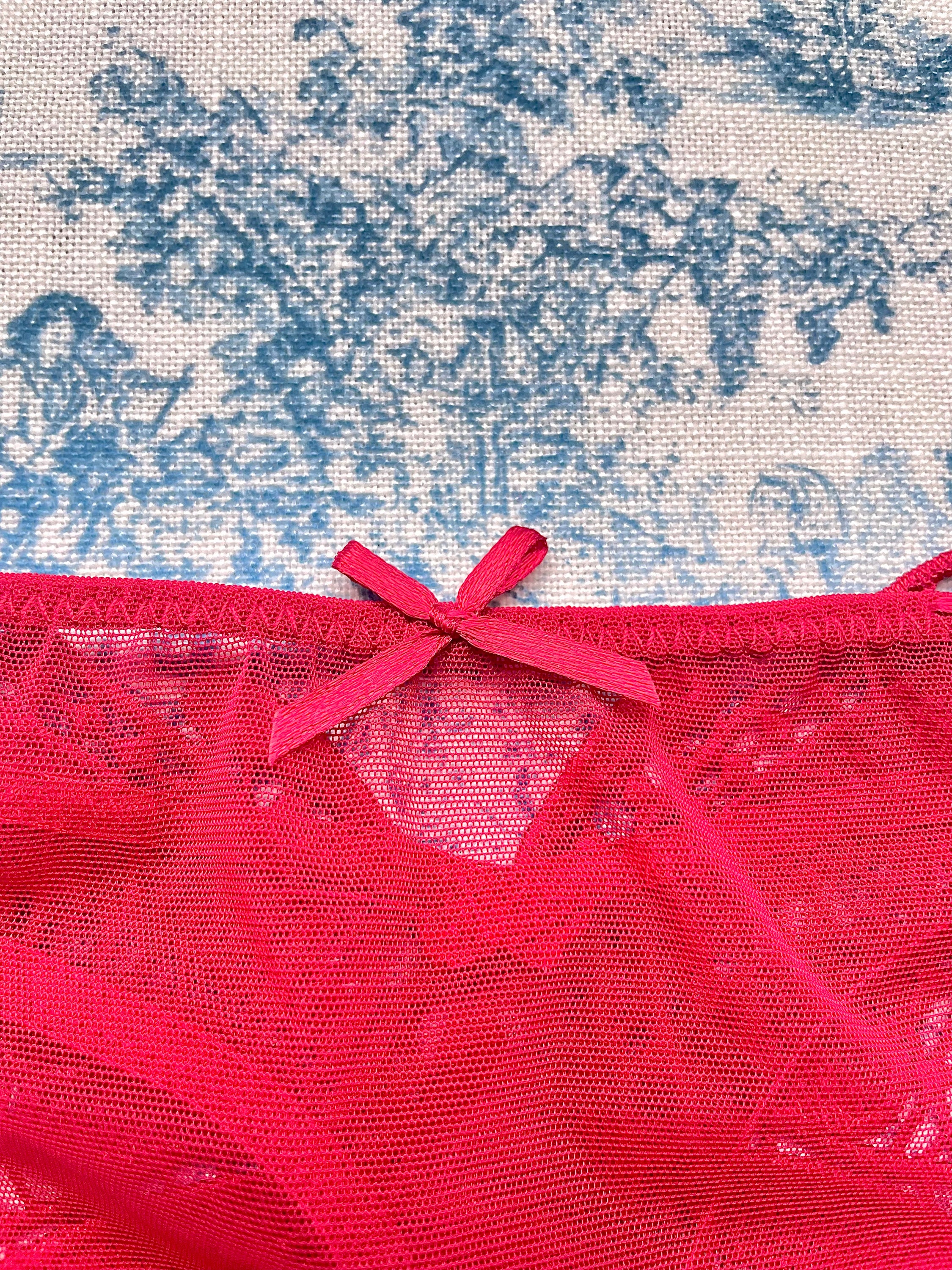 Red mesh butterfly panty featuring a playful butterfly design on the back and comfortable cotton lining.