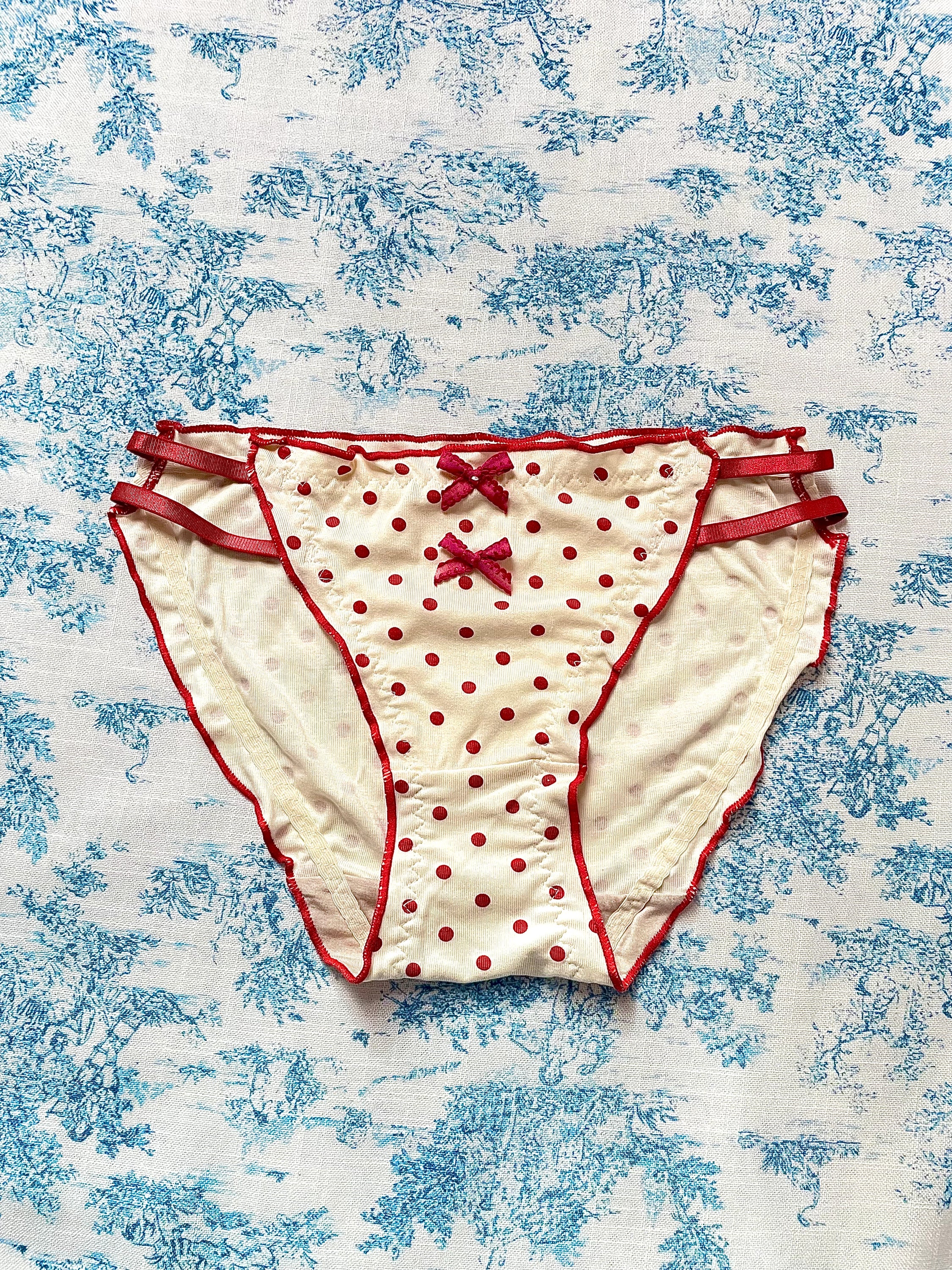 Red Polka Dot Panty with delicate lettuce trim and bow details, showcasing a playful design.