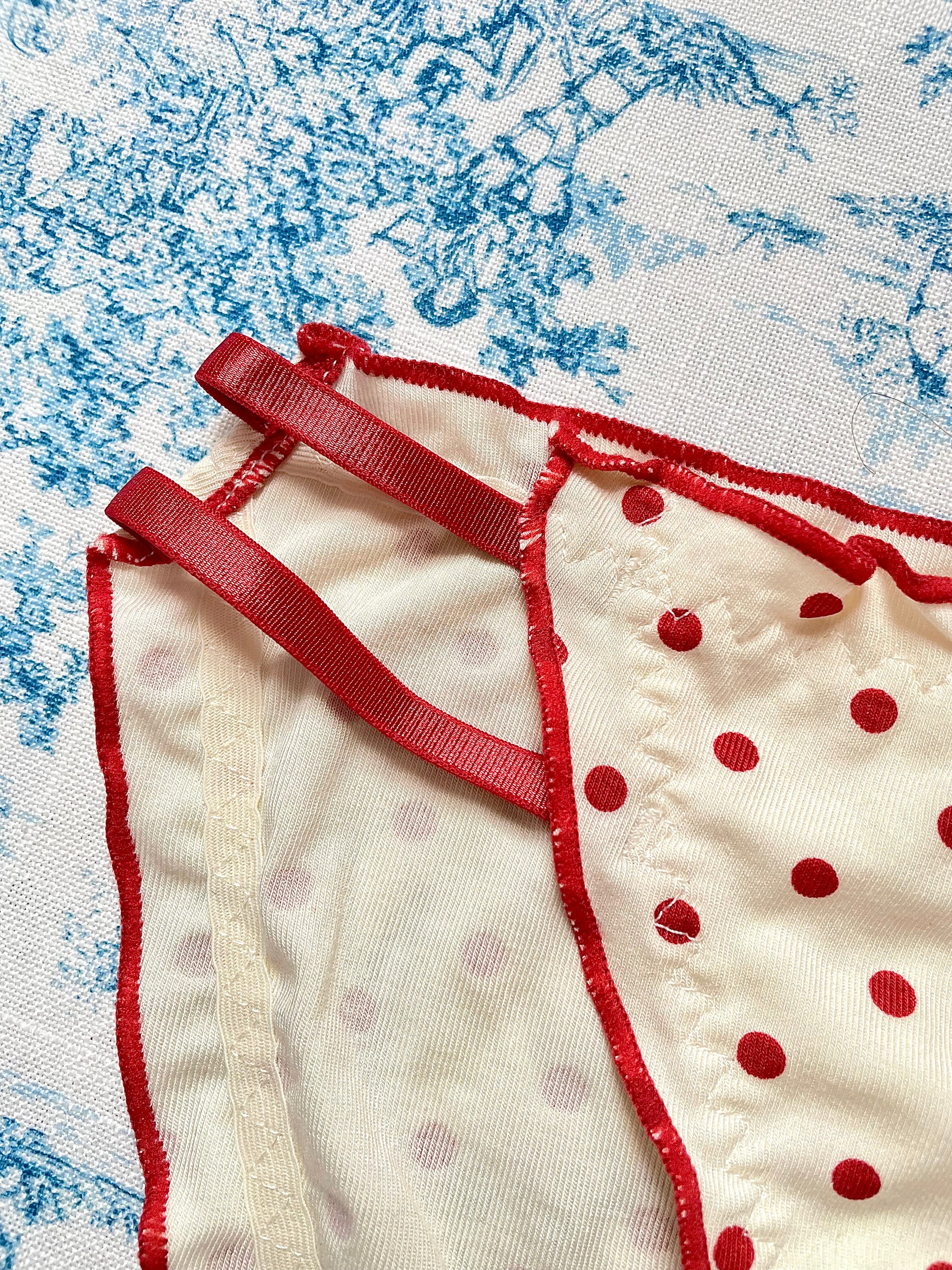 Red Polka Dot Panty with delicate lettuce trim and bow details, showcasing a playful design.