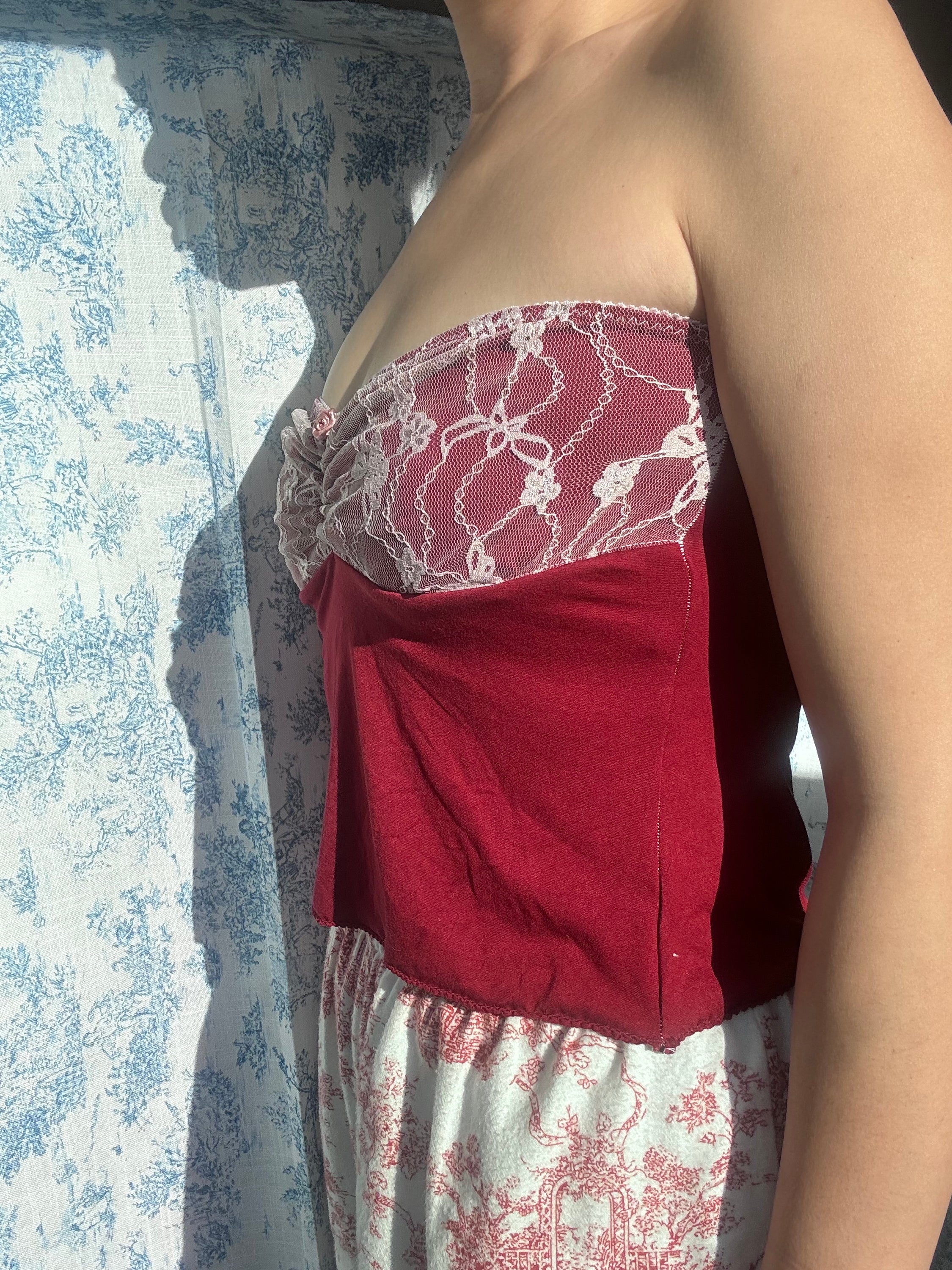 A stylish Red Rose 90s style camitop featuring intricate lacework and adjustable cami straps, perfect for a vintage-inspired look.