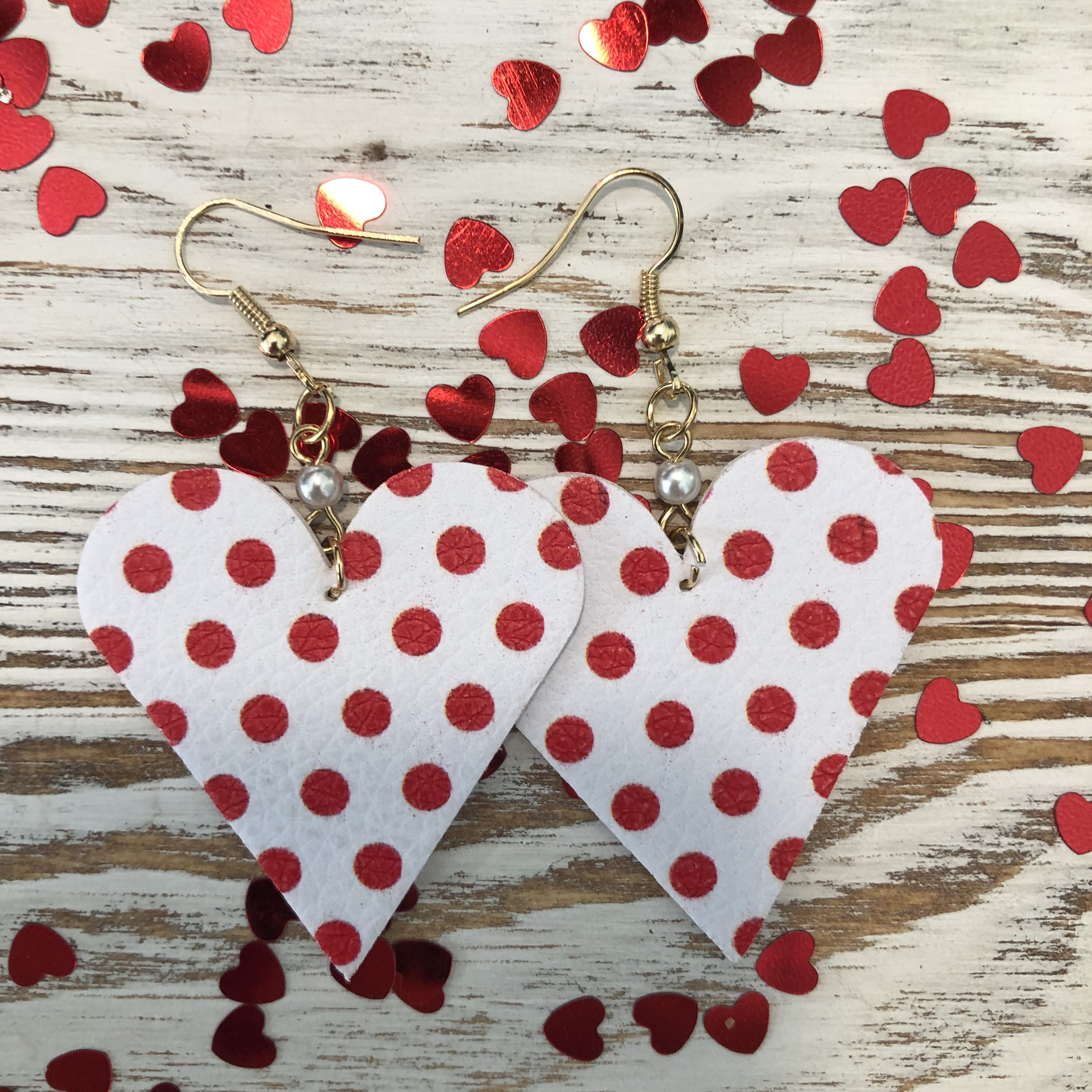 Red and white polka dot mini heart leather earrings with pearl accents, featuring a fish hook design for easy wear.