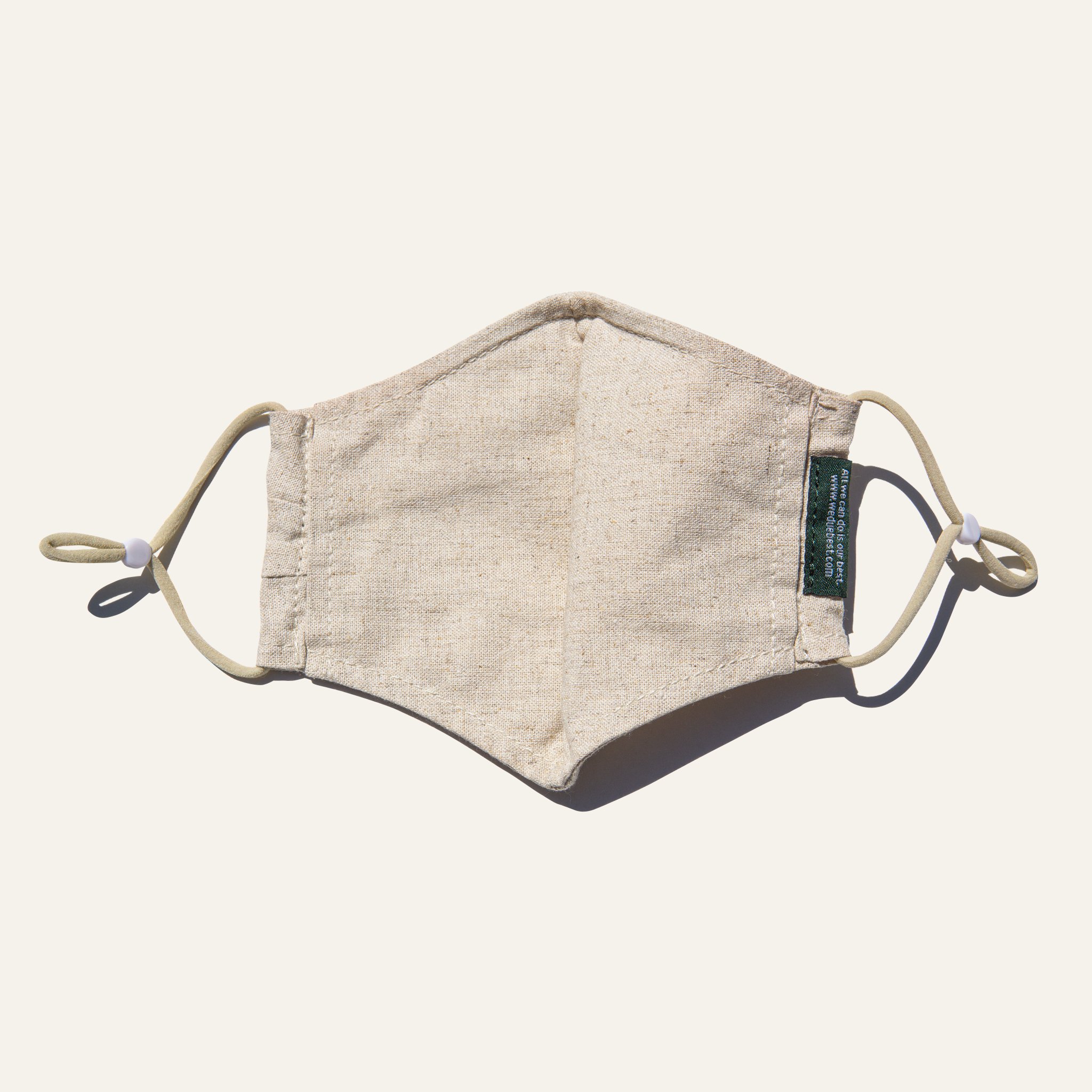 Natural Reusable Fabric Mask made from cotton and linen blend, featuring adjustable earloops and pleated design for comfort and coverage.