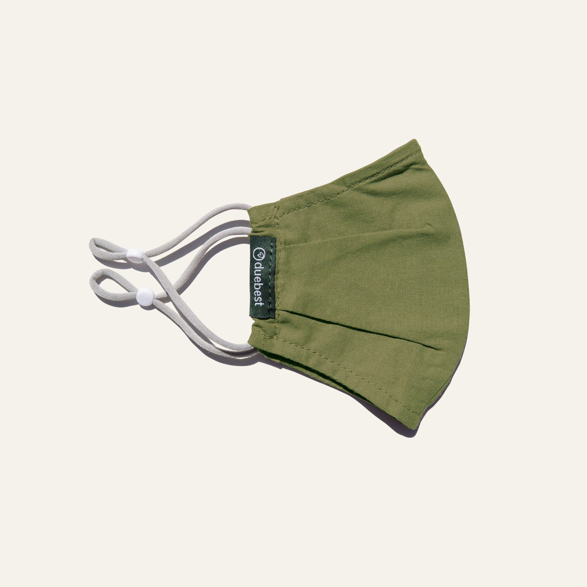 Olive green reusable fabric mask made from cotton and linen blend, featuring adjustable earloops and pleated design for comfort and coverage.