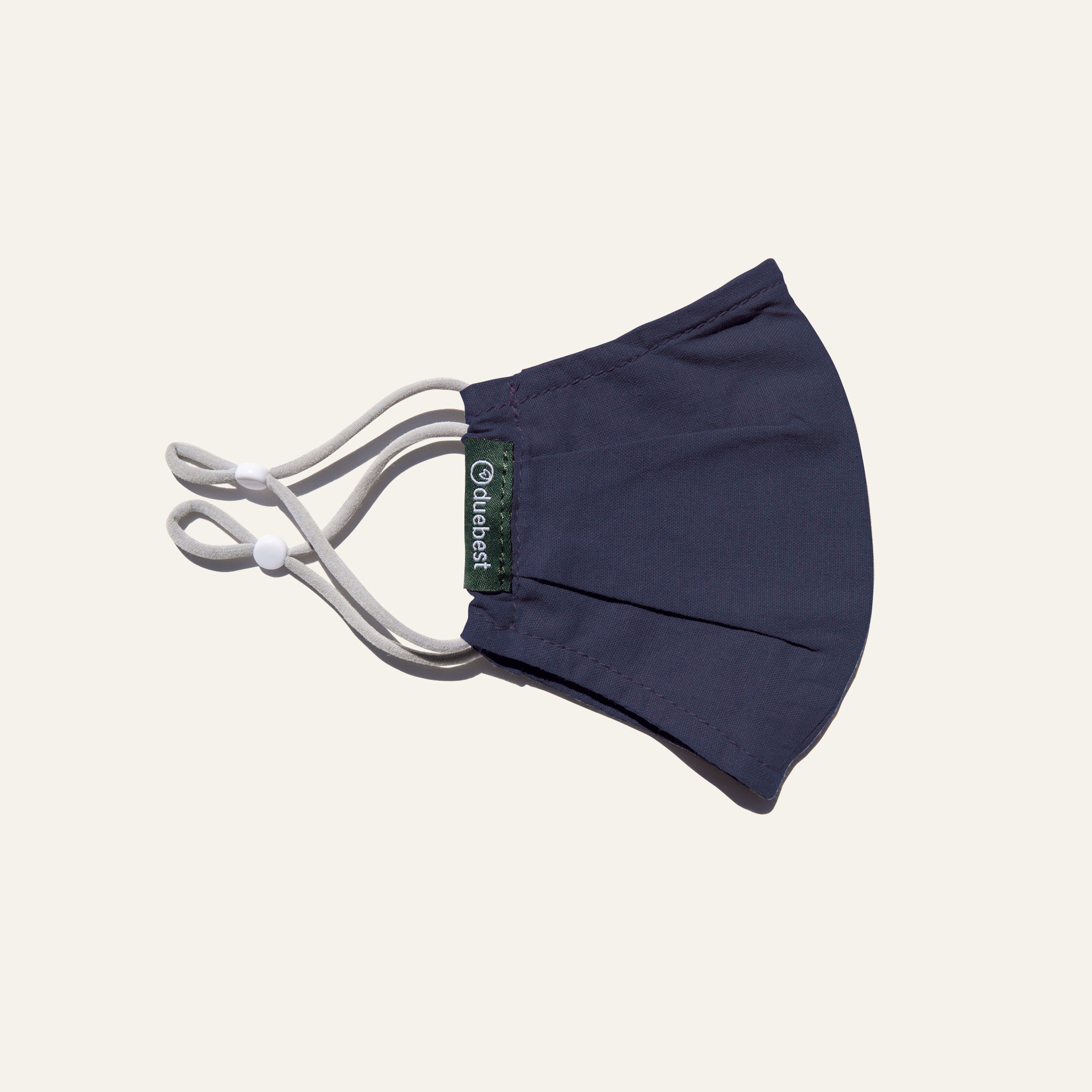 Olive green reusable fabric mask made from cotton and linen blend, featuring adjustable earloops and pleated design for comfort and coverage.