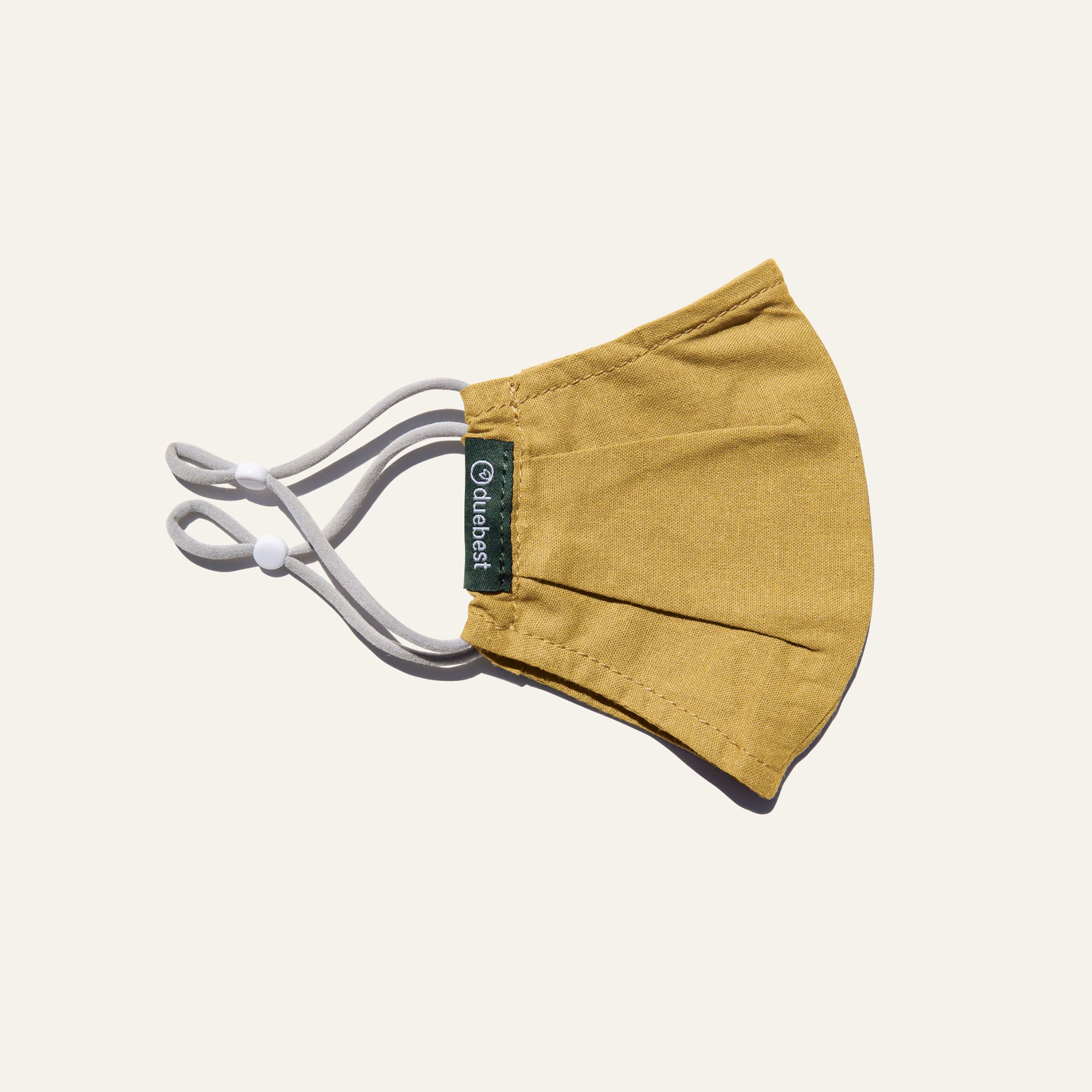 Olive green reusable fabric mask made from cotton and linen blend, featuring adjustable earloops and pleated design for comfort and coverage.