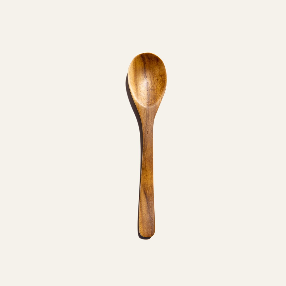 Handcrafted Reusable Teak Wood Spoon showcasing natural grain and color, perfect for eco-friendly dining.