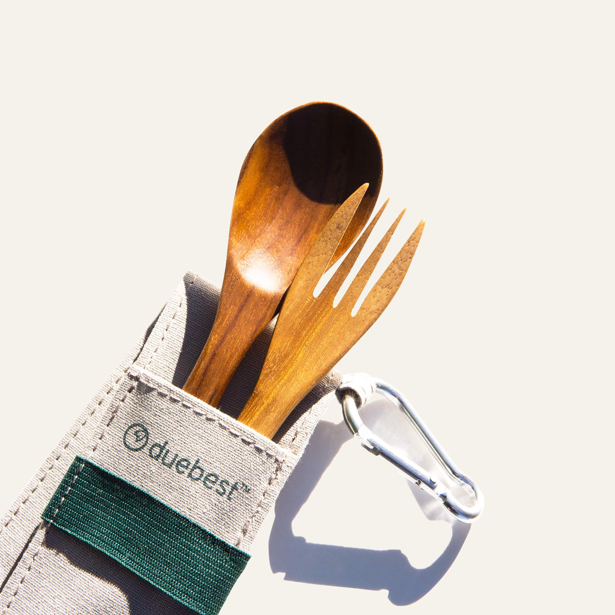 Compact Duebest™ reusable wooden cutlery set featuring hand-carved teak utensils and a fabric case with a metal carabiner.