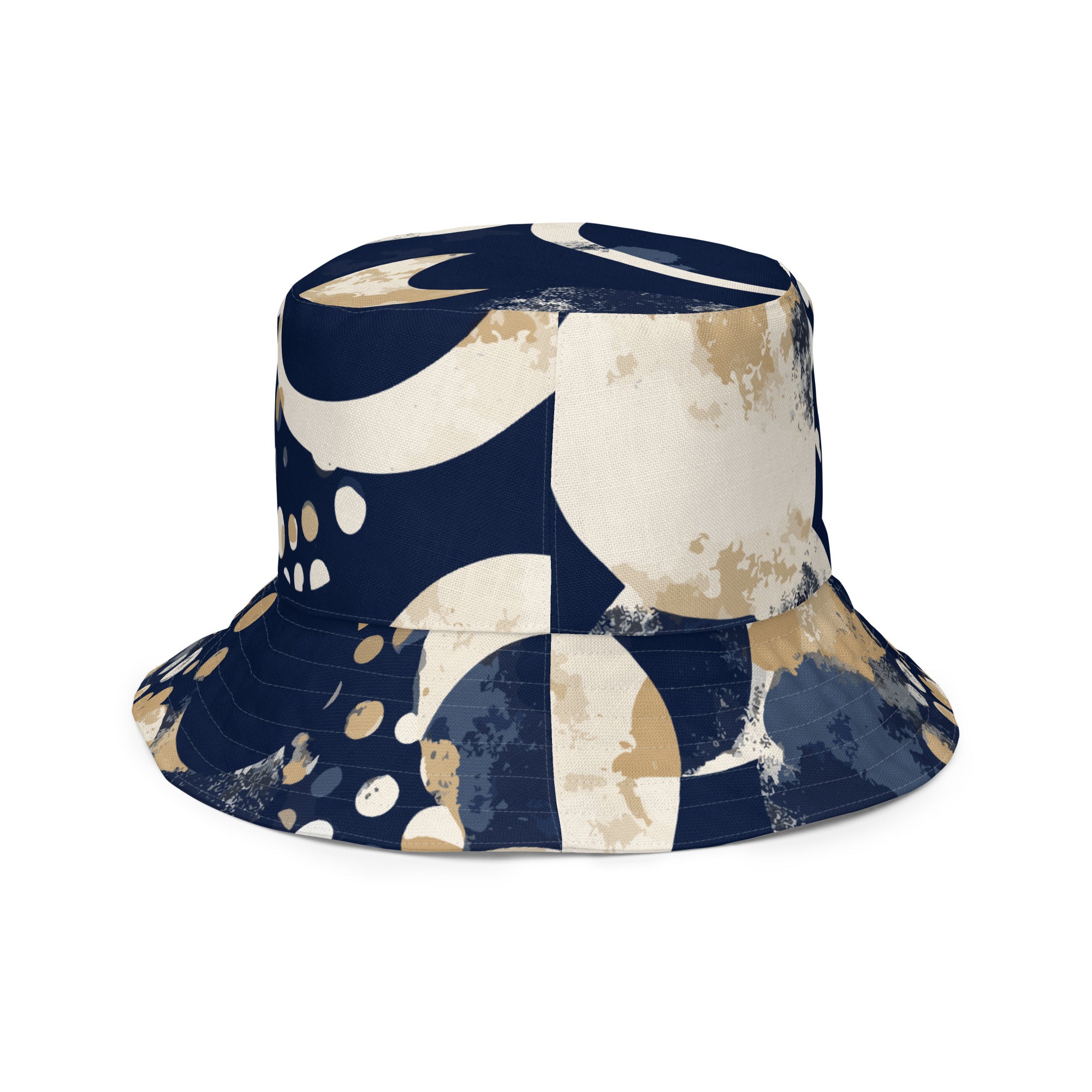 Reversible bucket hat featuring a blue and beige spotted print, showcasing both sides of the design.