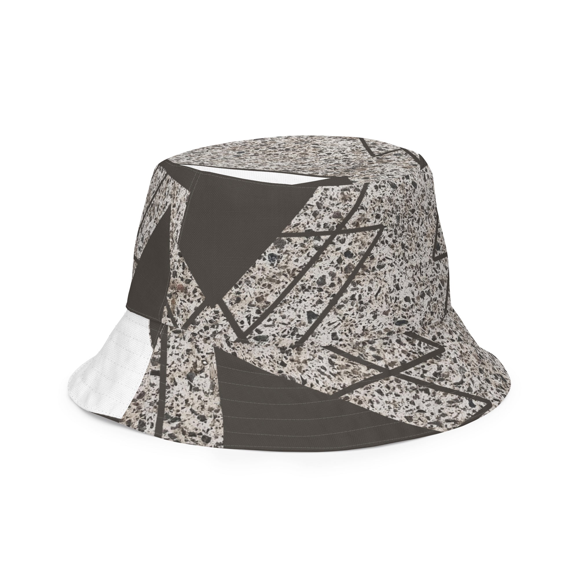 Reversible bucket hat featuring a brown and white triangular colorblock design, showcasing its stylish and versatile look.