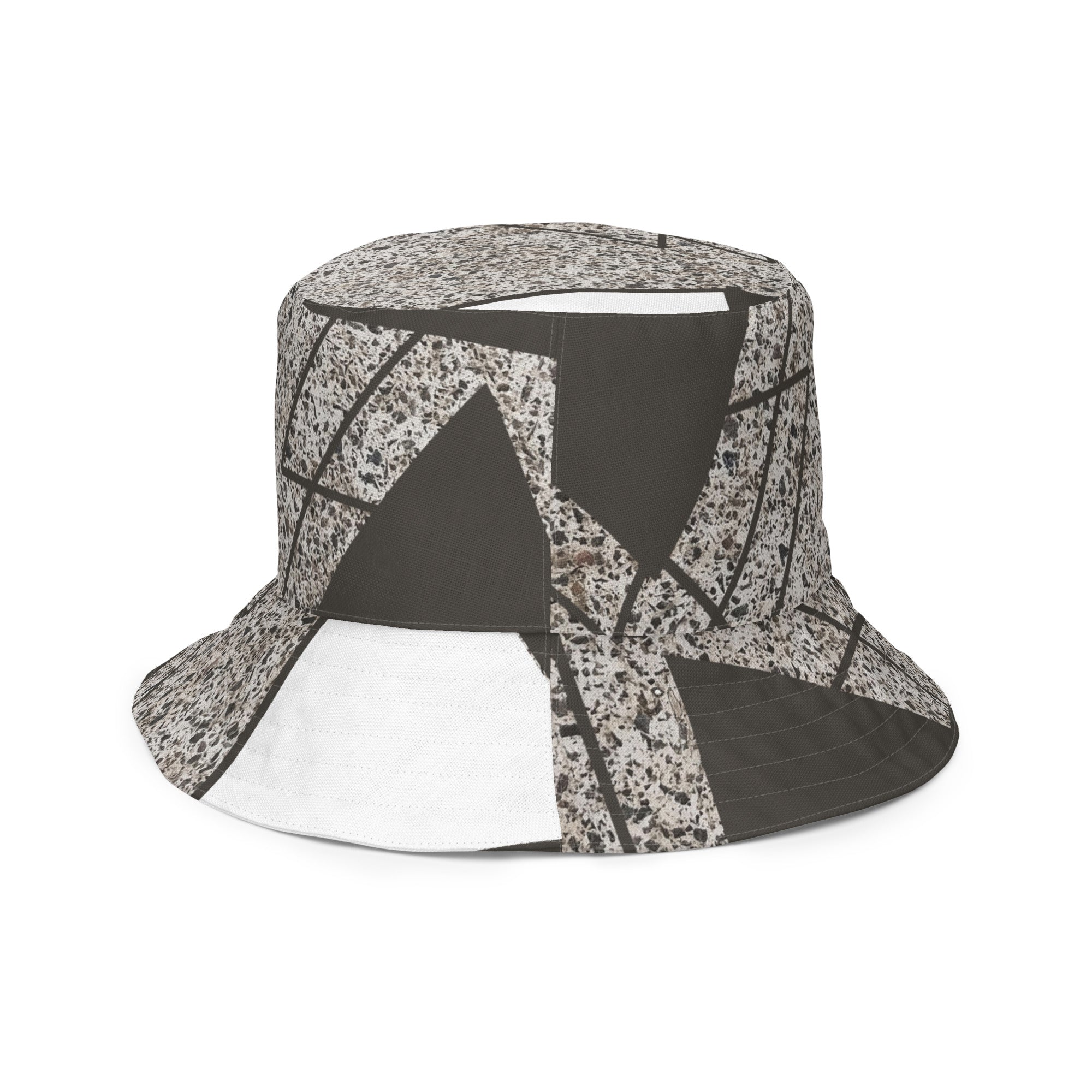 Reversible bucket hat featuring a brown and white triangular colorblock design, showcasing its stylish and versatile look.