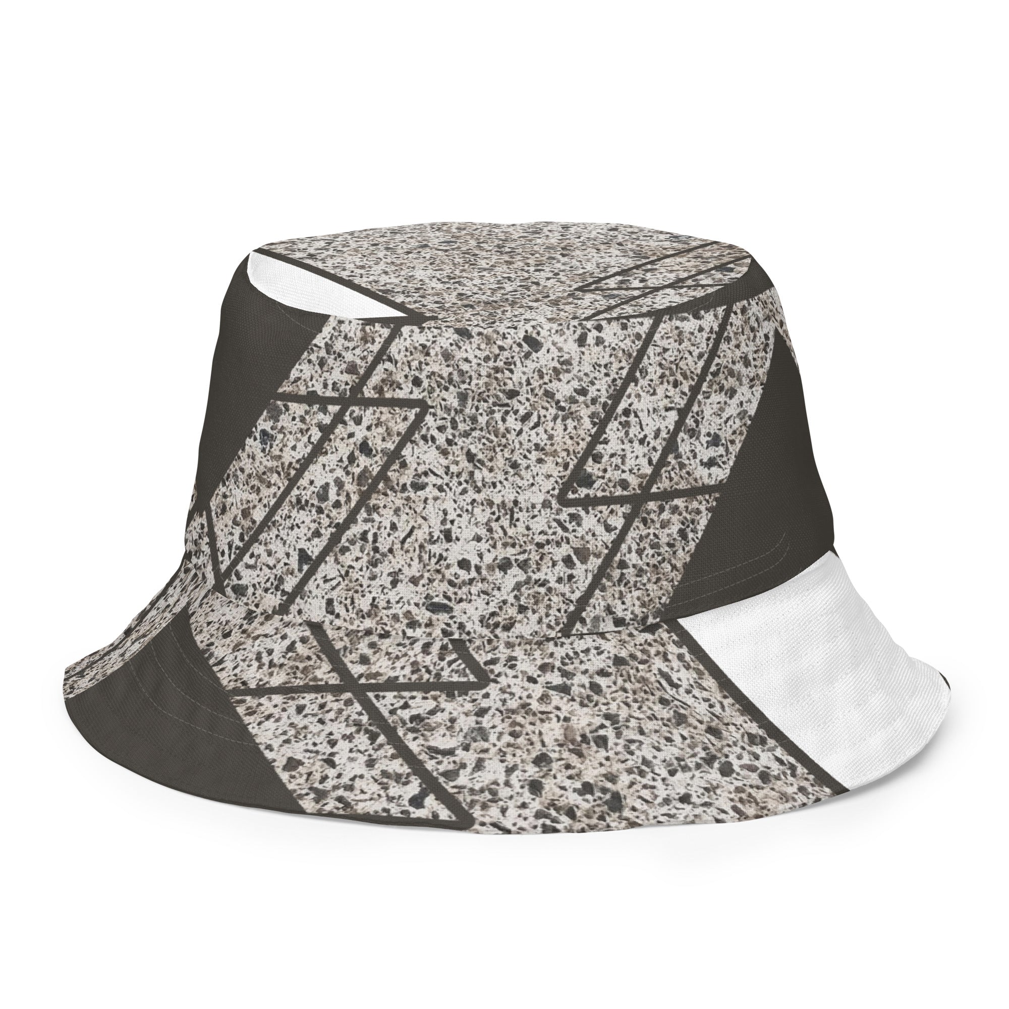 Reversible bucket hat featuring a brown and white triangular colorblock design, showcasing its stylish and versatile look.