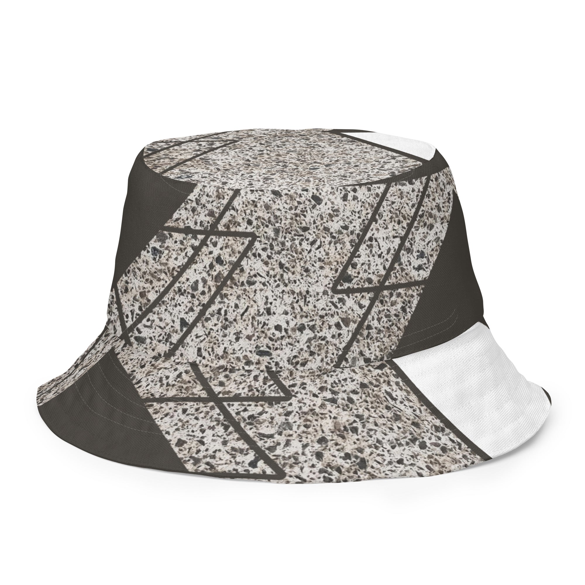 Reversible bucket hat featuring a brown and white triangular colorblock design, showcasing its stylish and versatile look.