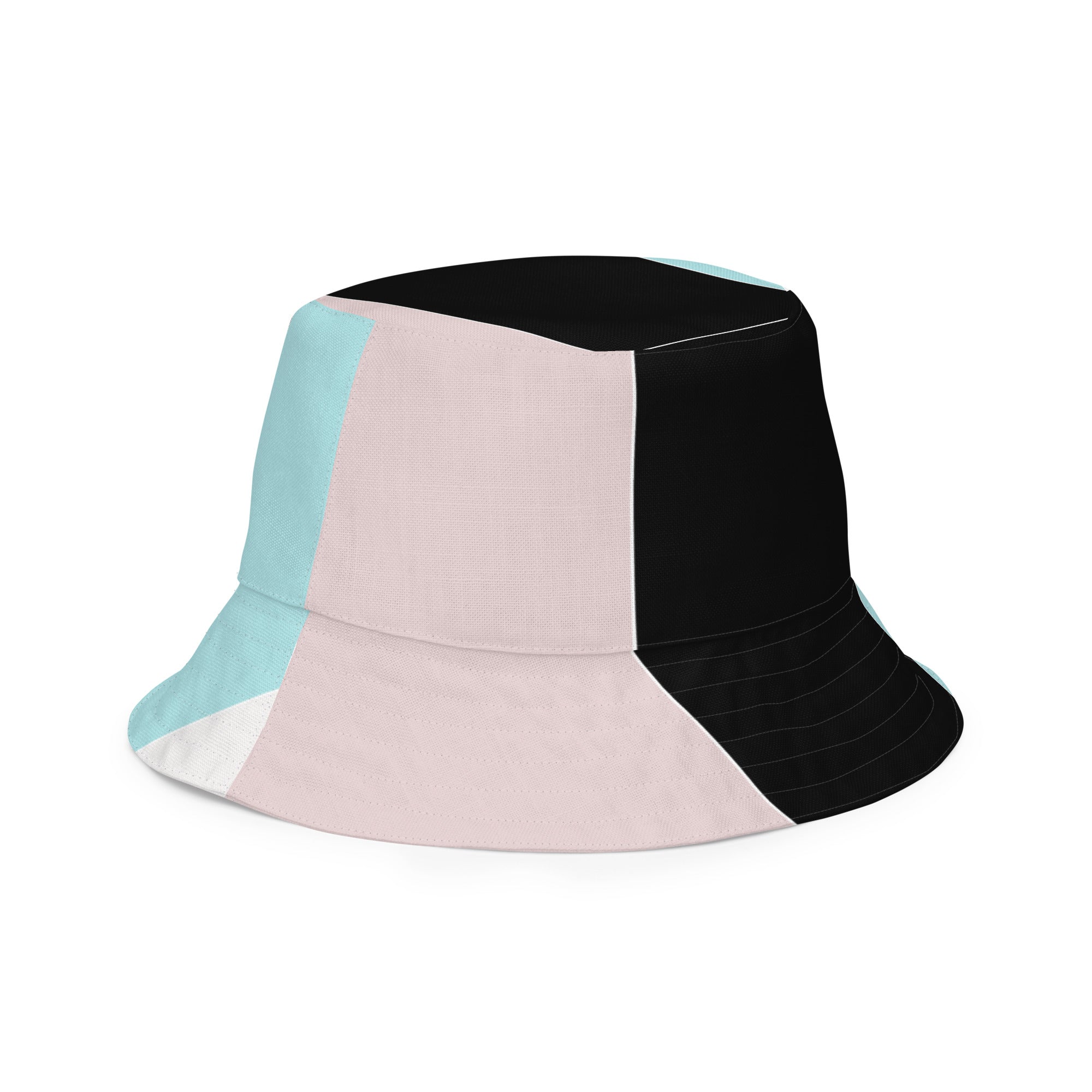 Reversible bucket hat featuring pastel pink, black, and blue colorblock design, showcasing both sides of the fabric.