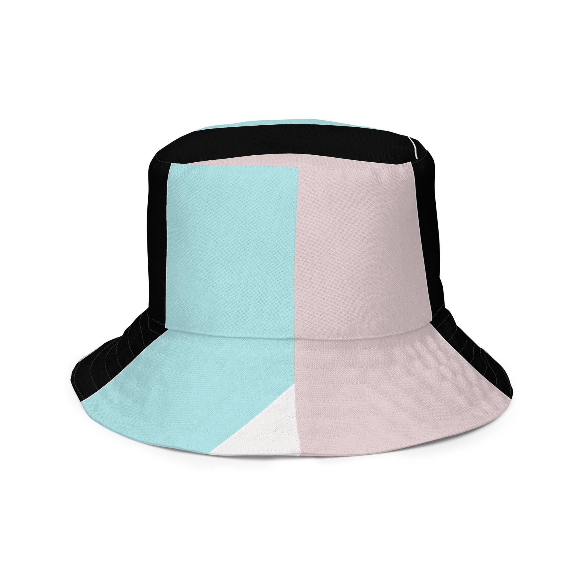 Reversible bucket hat featuring pastel pink, black, and blue colorblock design, showcasing both sides of the fabric.