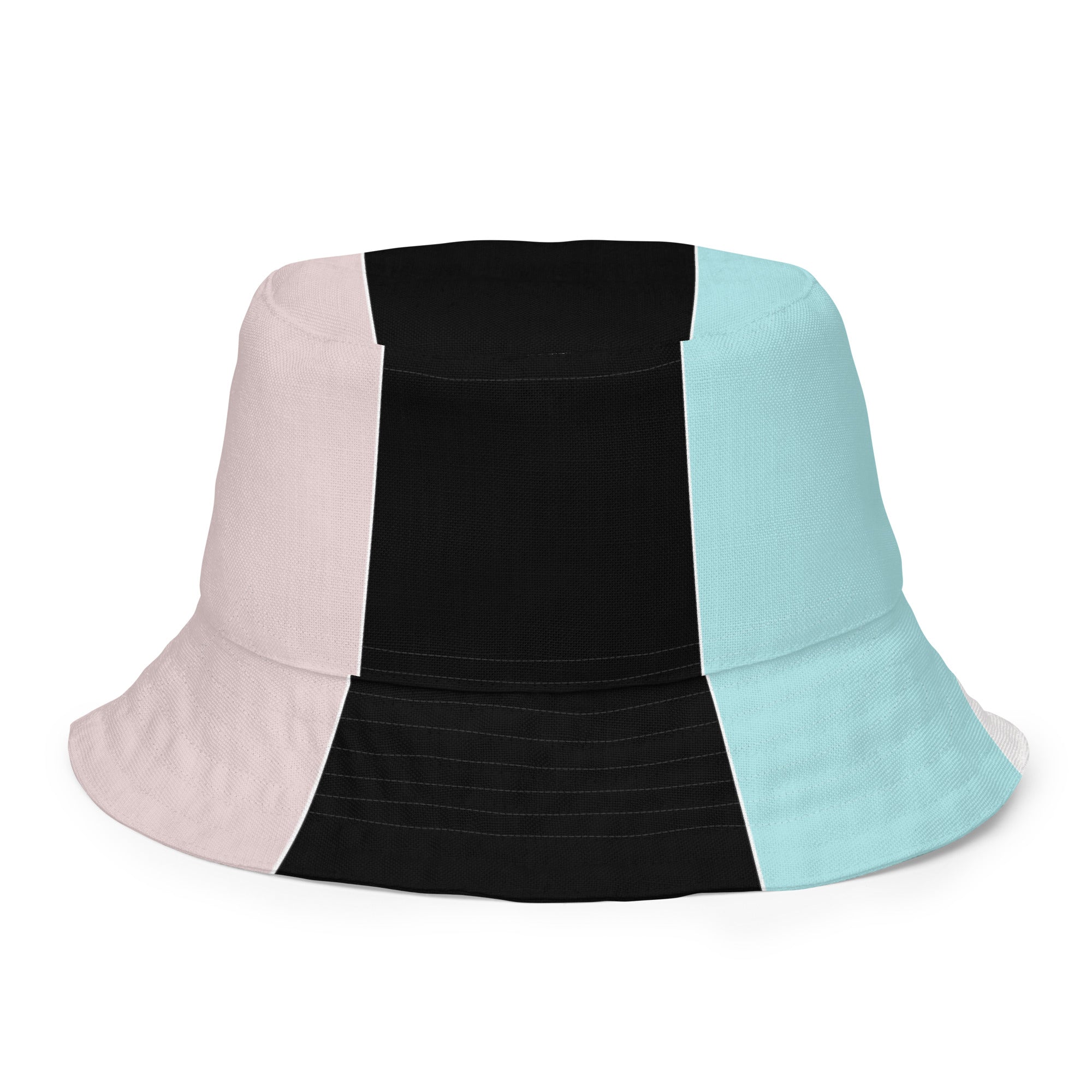 Reversible bucket hat featuring pastel pink, black, and blue colorblock design, showcasing both sides of the fabric.