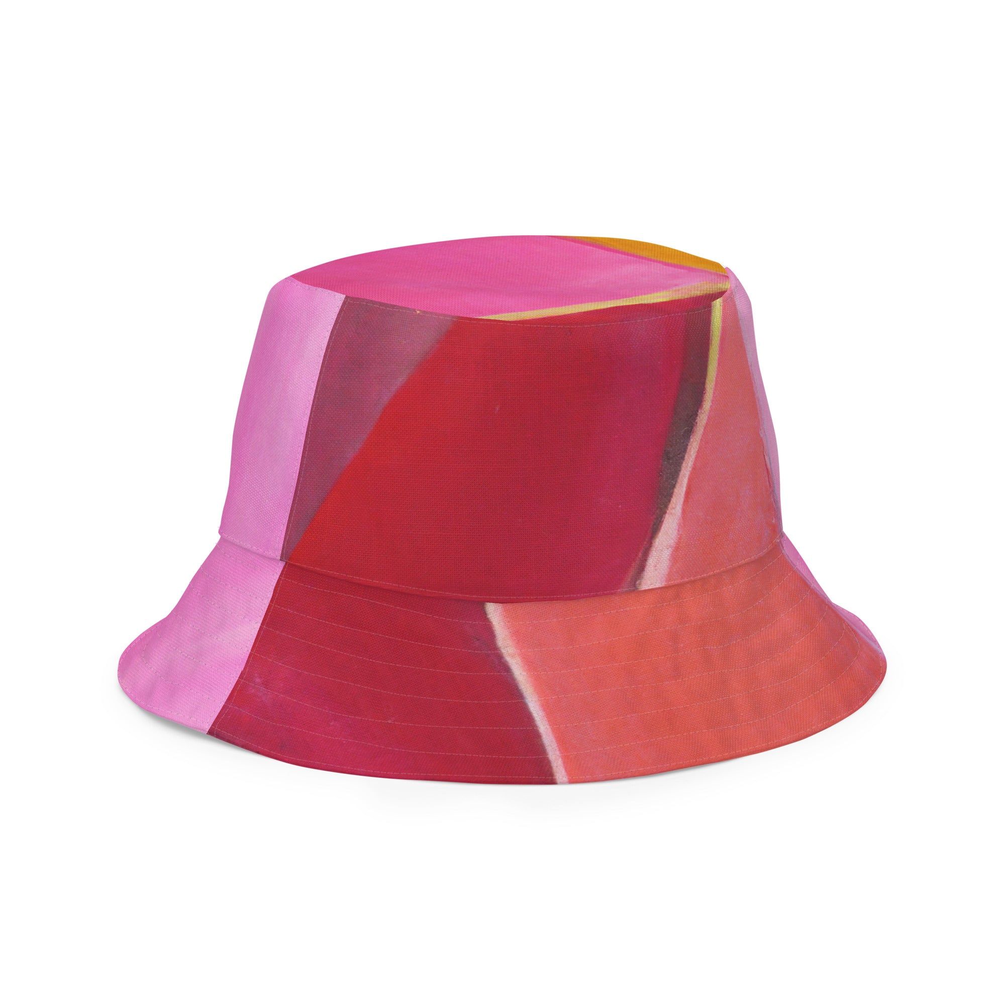 Reversible bucket hat featuring a pink mauve red geometric pattern, showcasing its stylish design and premium fabric.