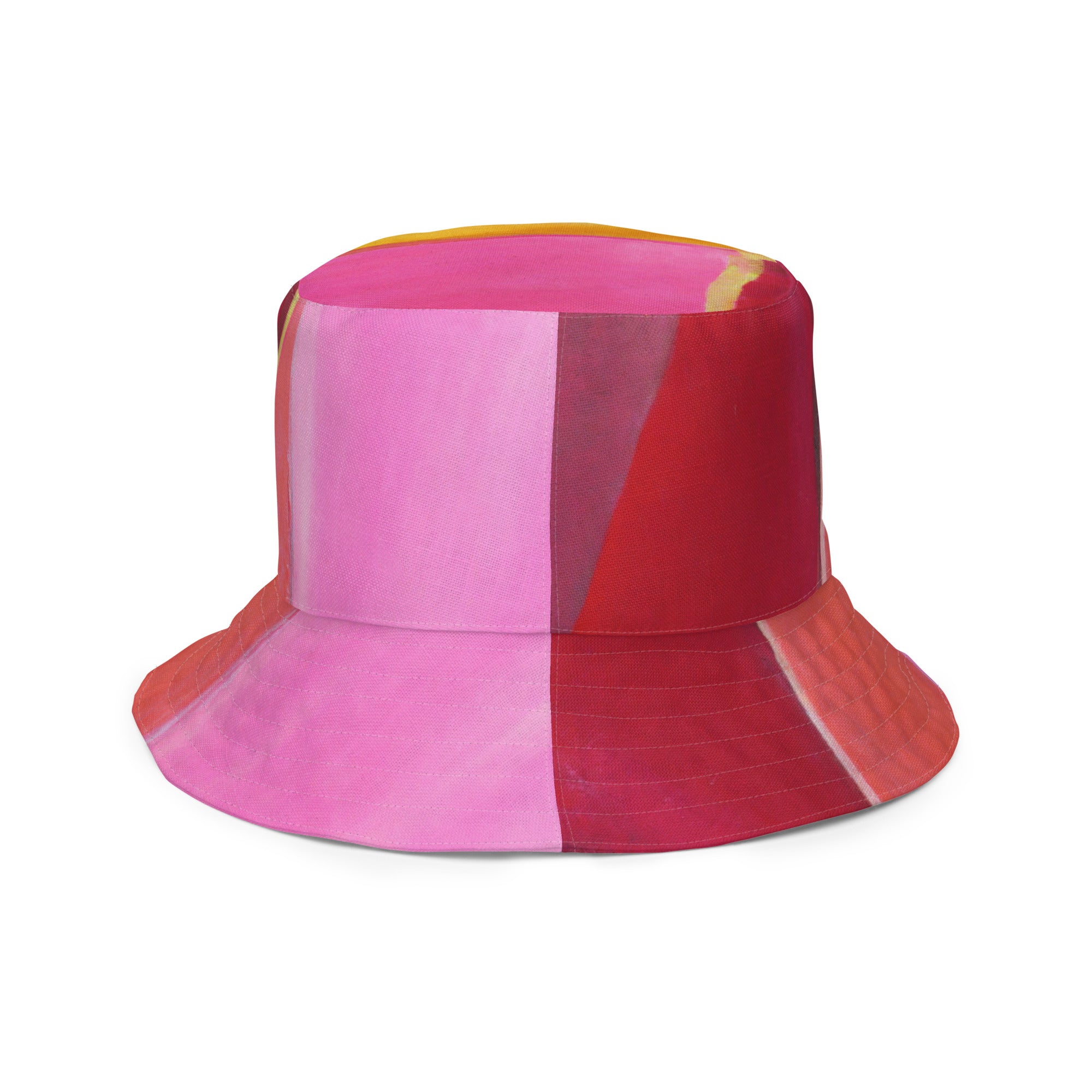 Reversible bucket hat featuring a pink mauve red geometric pattern, showcasing its stylish design and premium fabric.