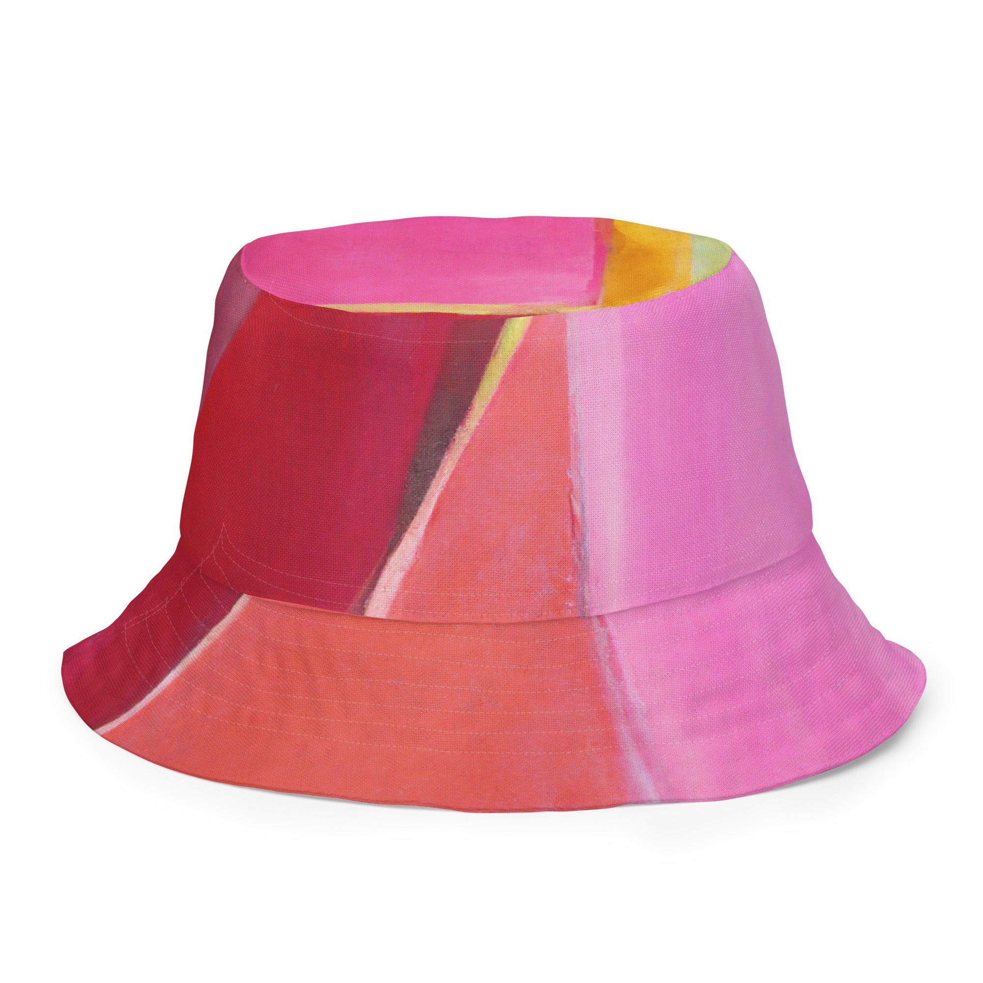 Reversible bucket hat featuring a pink mauve red geometric pattern, showcasing its stylish design and premium fabric.