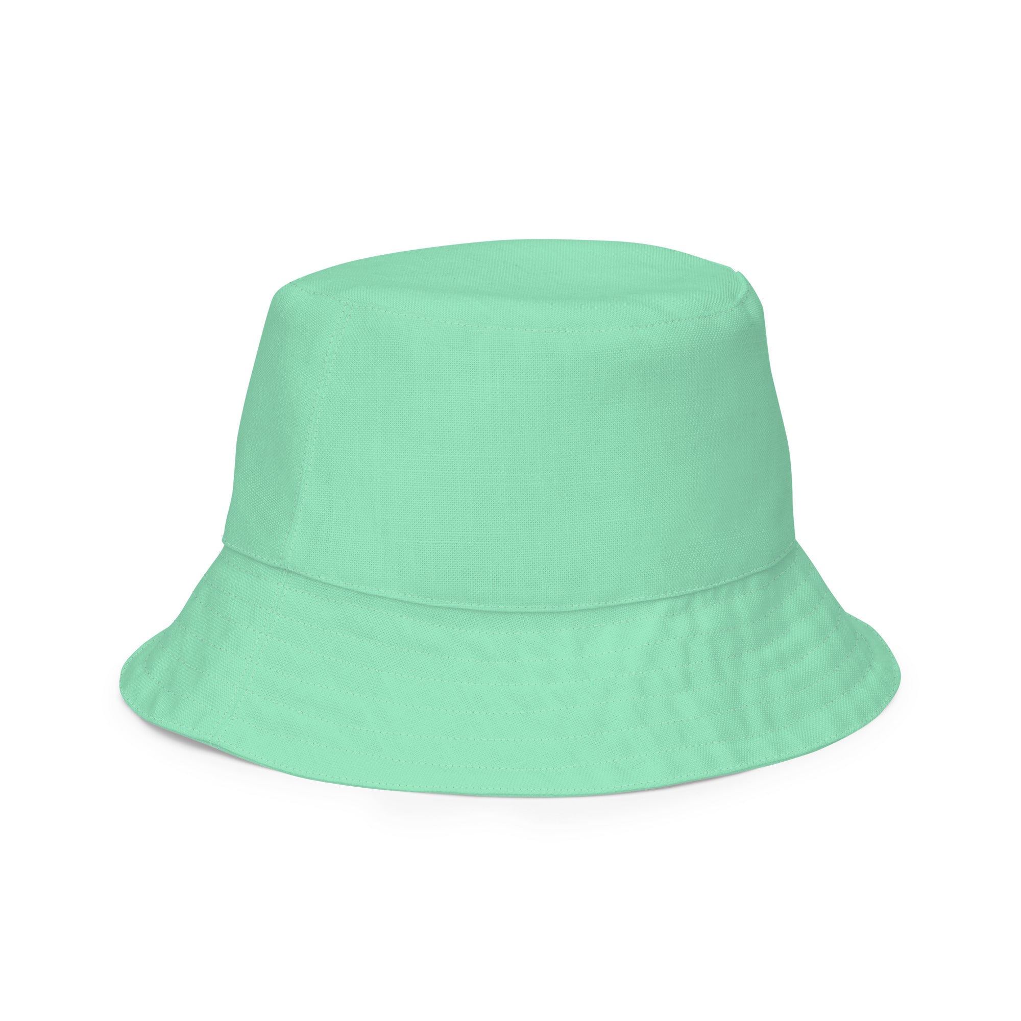 Reversible Bucket Hat in Seafoam Green, showcasing its dual-sided design and wide brim for sun protection.