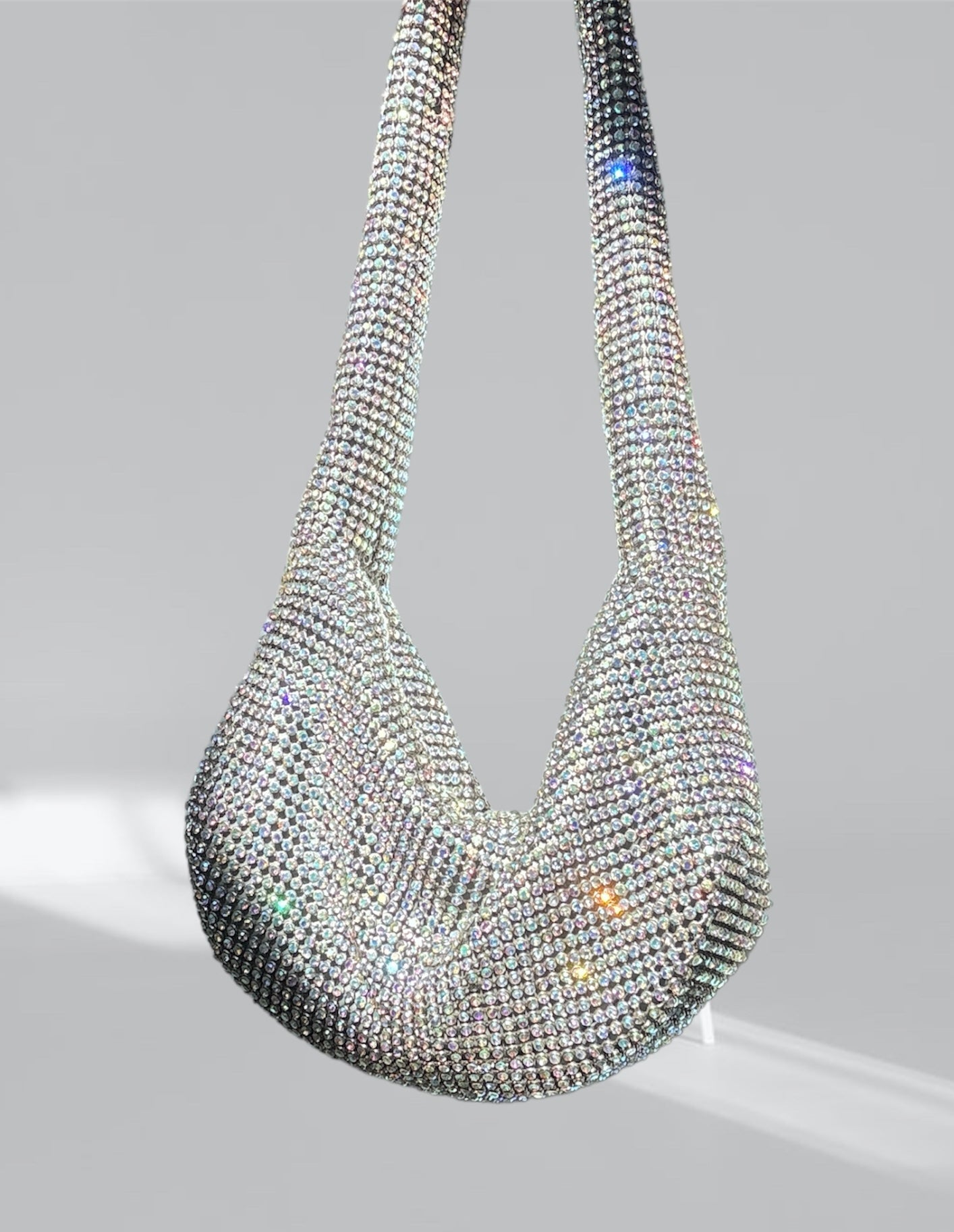 A stylish Rhinestone Mini Shoulder Bag featuring sparkling rhinestones and silver-tone accents, available in silver, red, and green.