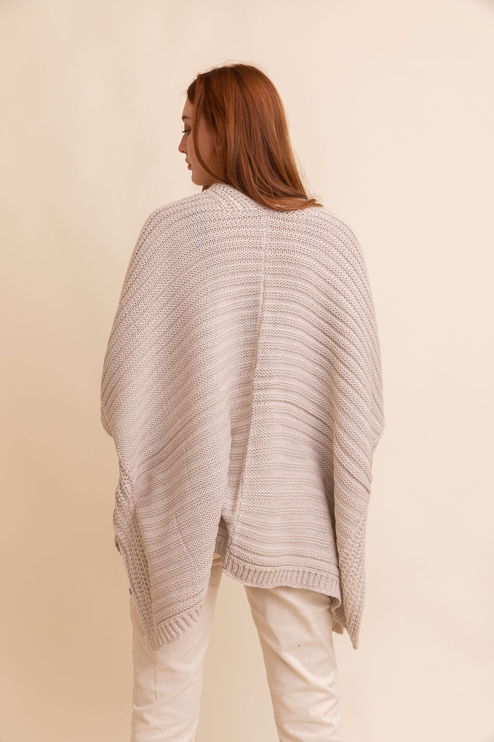 A cozy Ridged Rib Knit Ruana in a rich color, showcasing its ribbed texture and draped style, perfect for layering in colder months.