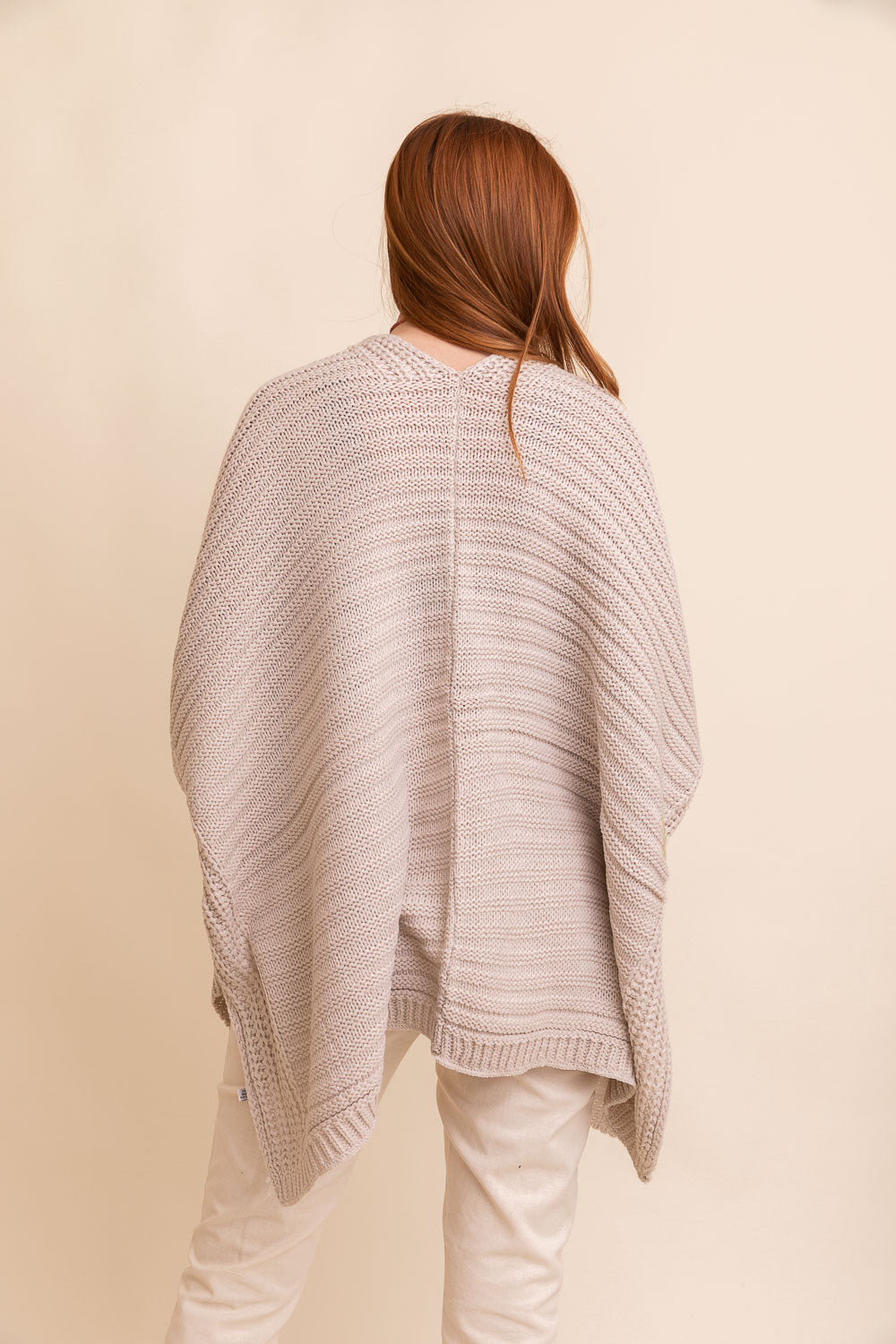 A cozy Ridged Rib Knit Ruana in a rich color, showcasing its ribbed texture and draped style, perfect for layering in colder months.