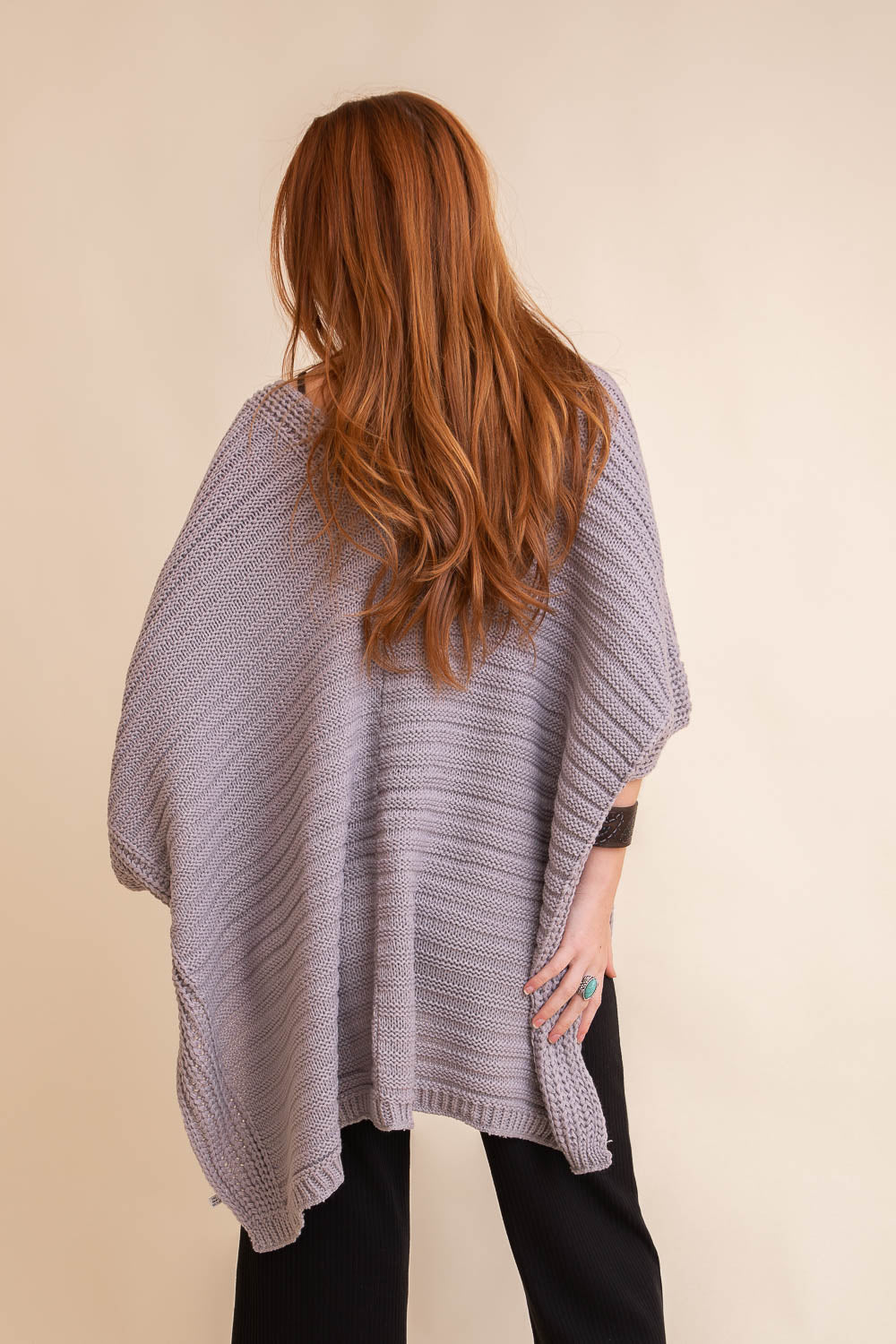 A cozy Ridged Rib Knit Ruana in a rich color, showcasing its ribbed texture and draped style, perfect for layering in colder months.