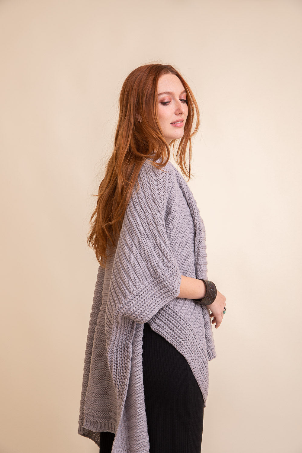 A cozy Ridged Rib Knit Ruana in a rich color, showcasing its ribbed texture and draped style, perfect for layering in colder months.