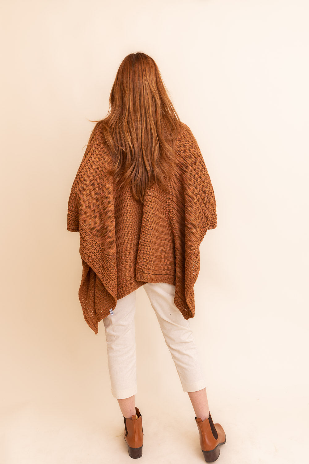 A cozy Ridged Rib Knit Ruana in a rich color, showcasing its ribbed texture and draped style, perfect for layering in colder months.