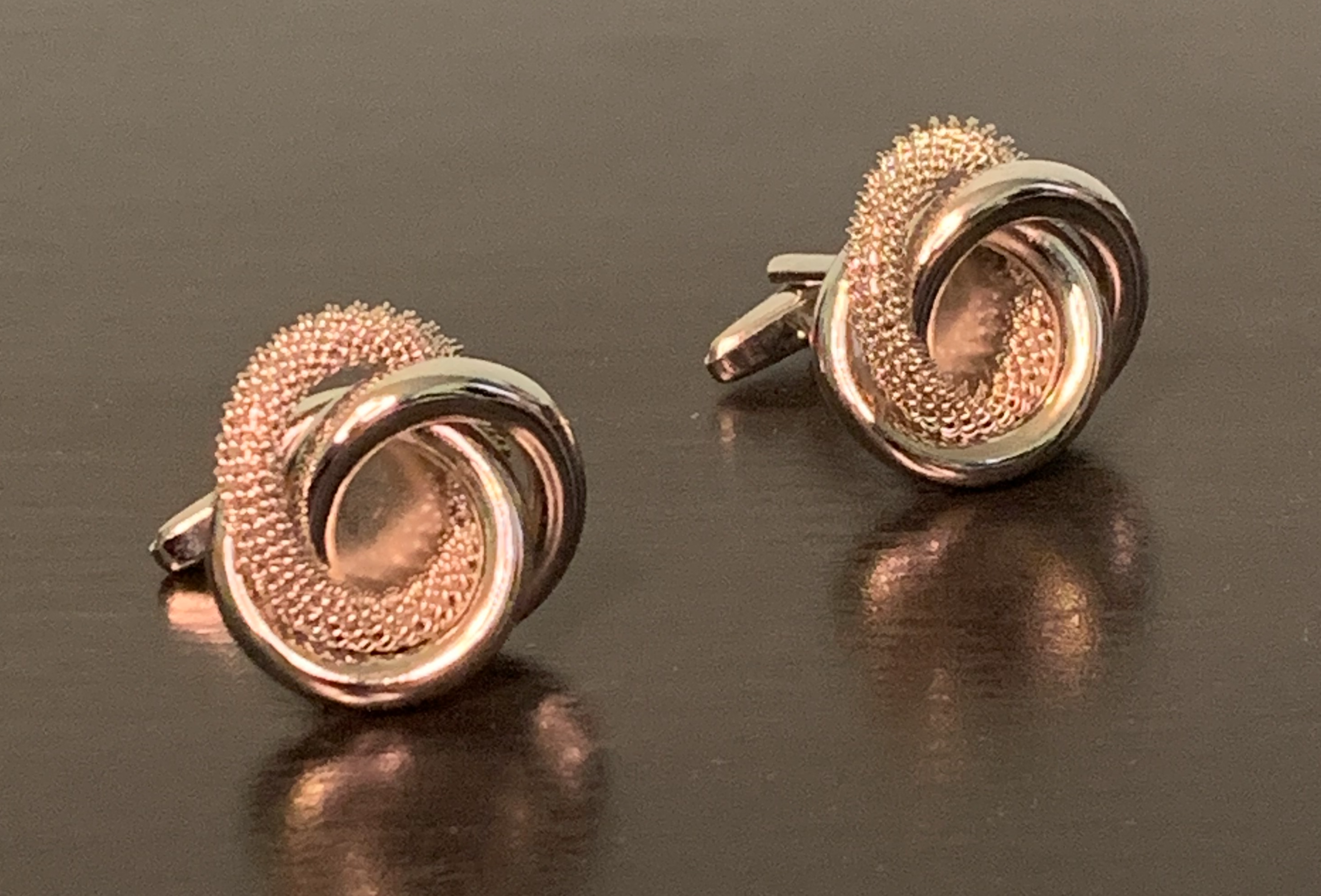 Stylish silver-coloured Rogue Twist Cufflinks with a unique twist design, symbolizing resilience and elegance.