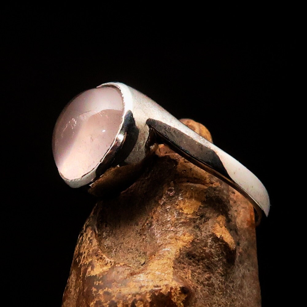 A stunning rose quartz ring set in polished sterling silver, featuring a round cabochon stone, perfect for elegant occasions.