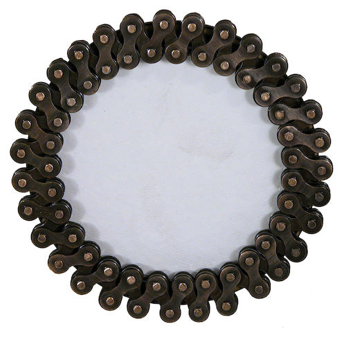 A round photo frame made from upcycled bicycle chains, showcasing a unique and eco-friendly design, perfect for displaying cherished memories.