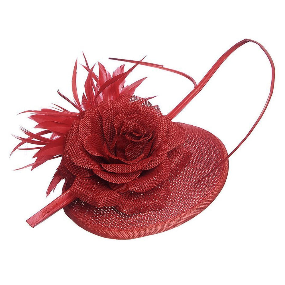 Ruby Rocks Cruz Fascinator in red with a large rose and feather details on a disc base, secured with a hair clip.