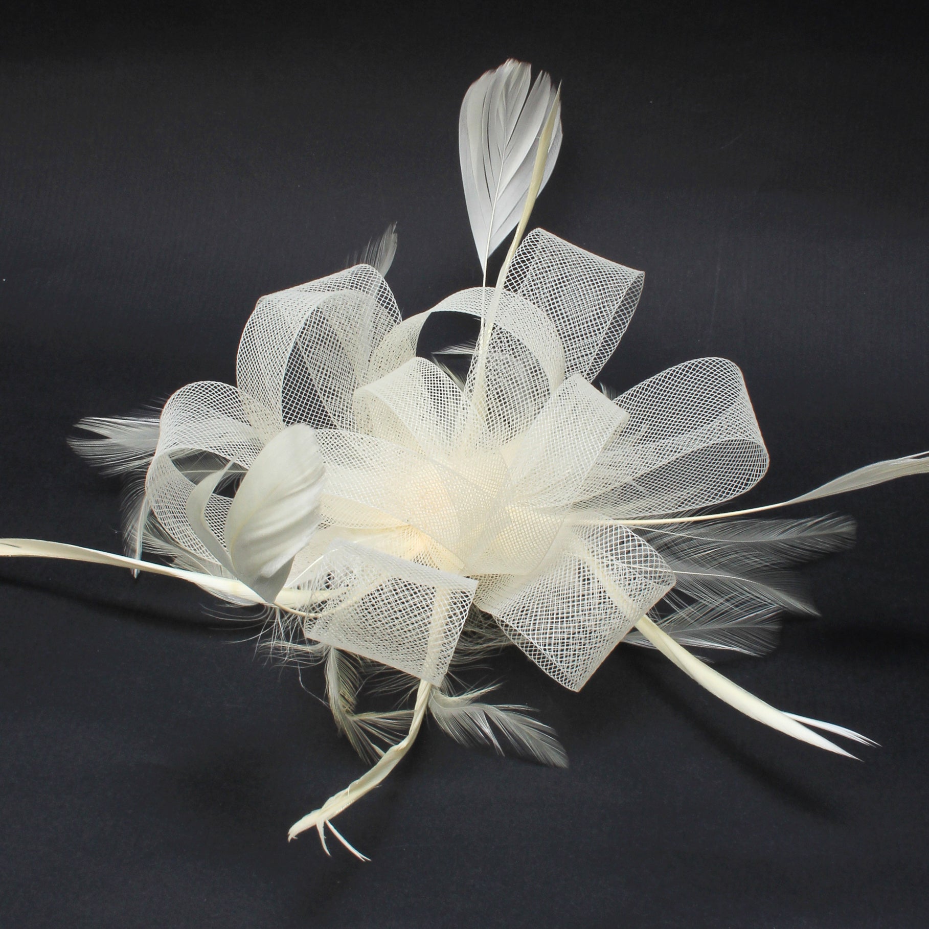 Ruby Rocks Grace Fascinator in cream featuring organza and faux feathers, elegantly designed for special occasions.