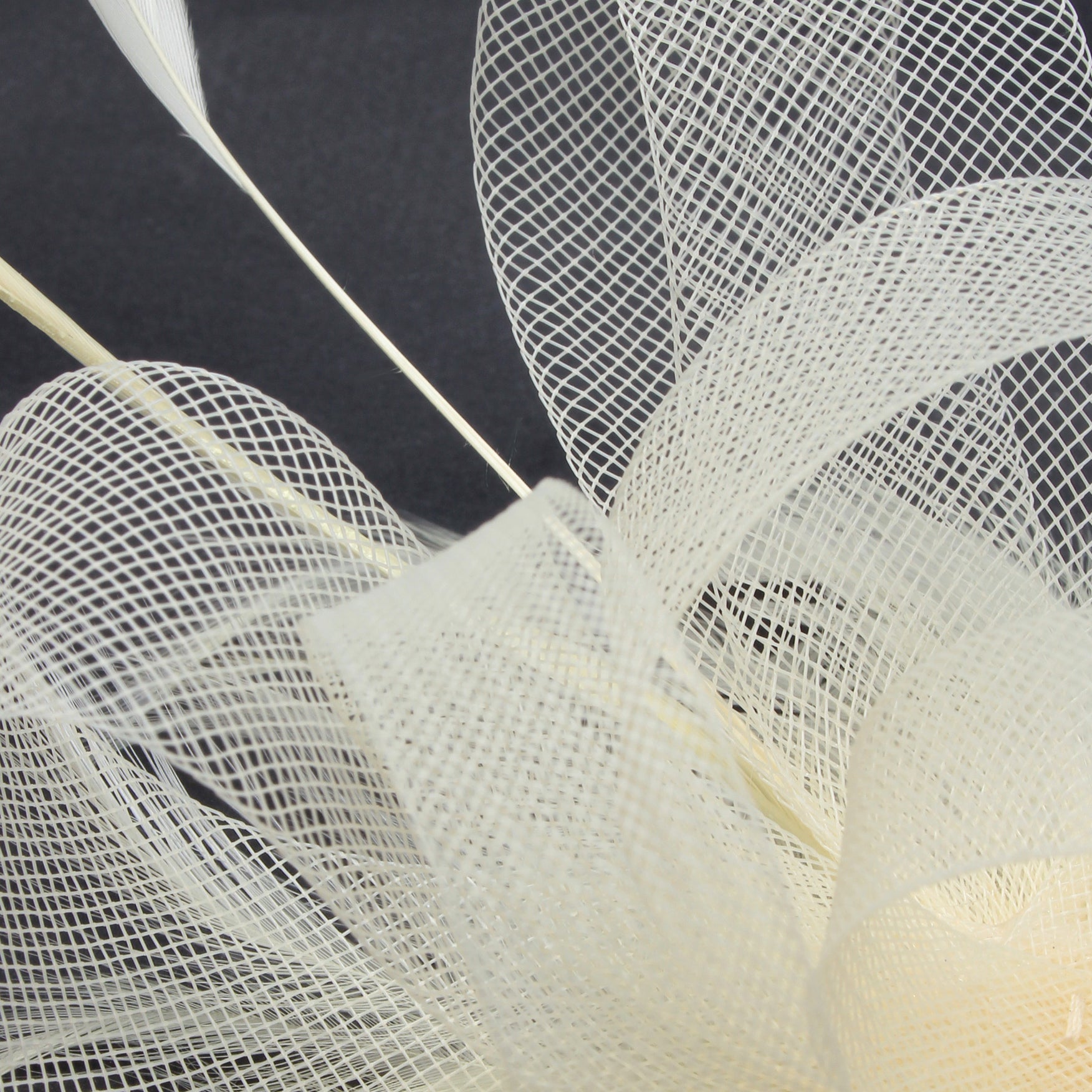 Ruby Rocks Grace Fascinator in cream featuring organza and faux feathers, elegantly designed for special occasions.