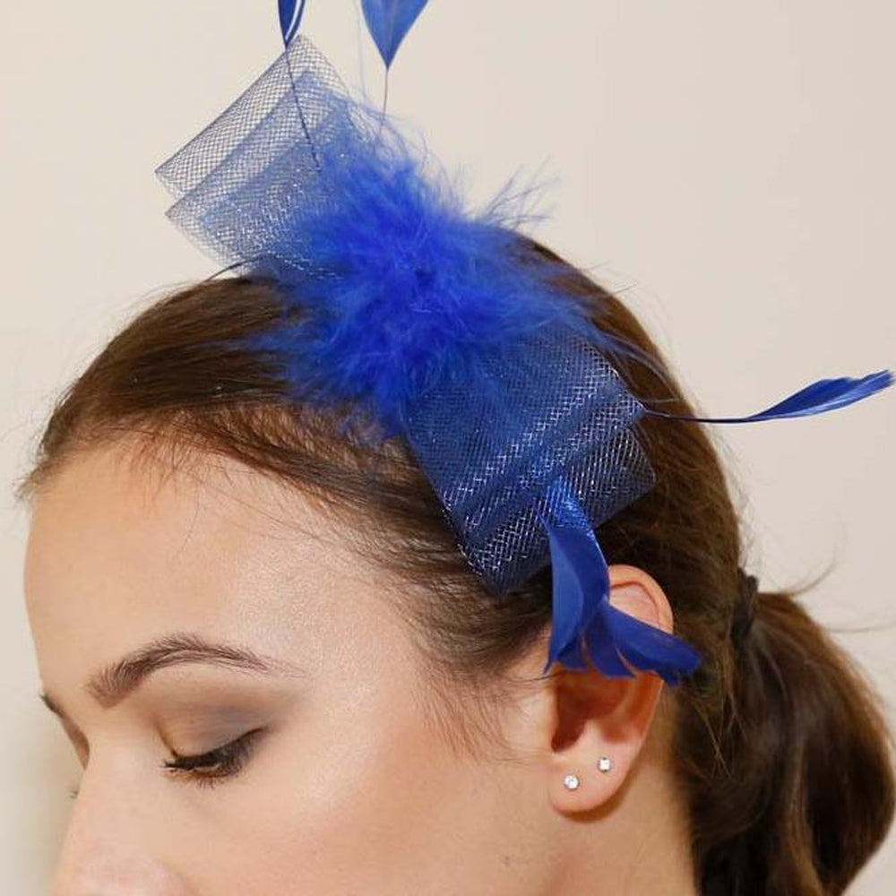 Ruby Rocks Mati Fascinator in blue featuring fur and feathers with an elegant bow on a headband.