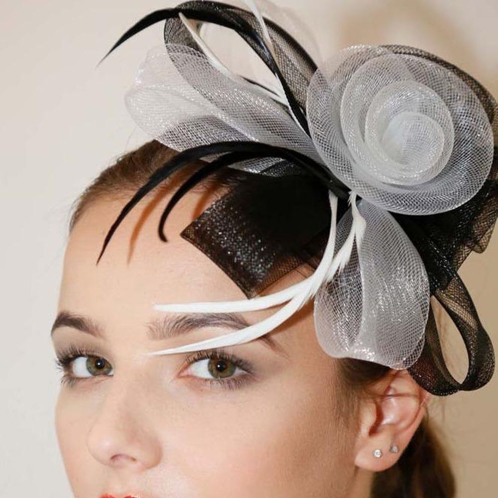 Ruby Rocks Sancha Fascinator in Black and White featuring a flower and feather design, secured with a hair clip.