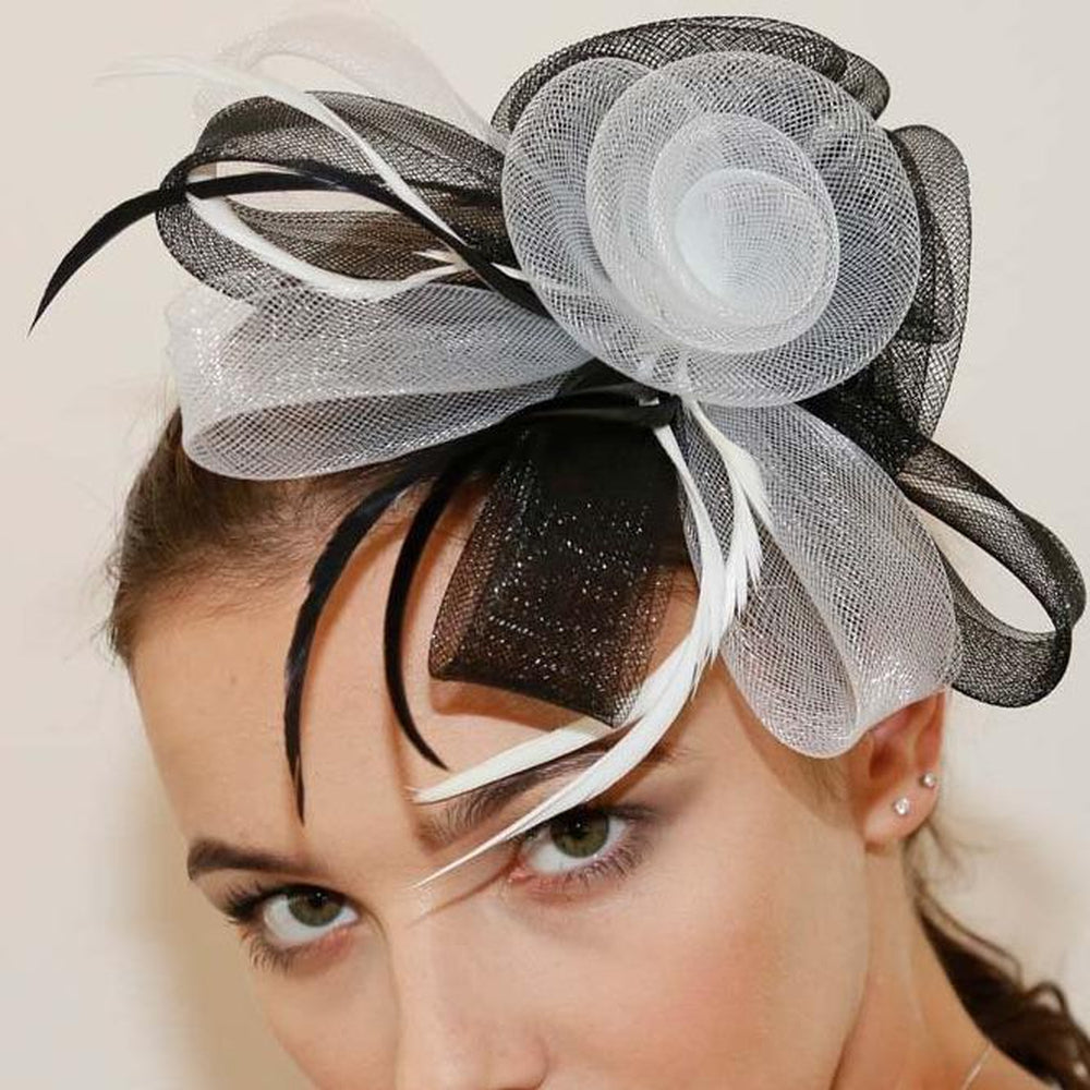 Ruby Rocks Sancha Fascinator in Black and White featuring a flower and feather design, secured with a hair clip.