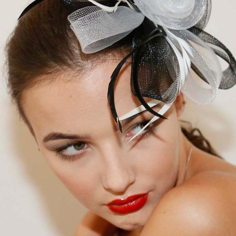 Ruby Rocks Sancha Fascinator in Black and White featuring a flower and feather design, secured with a hair clip.