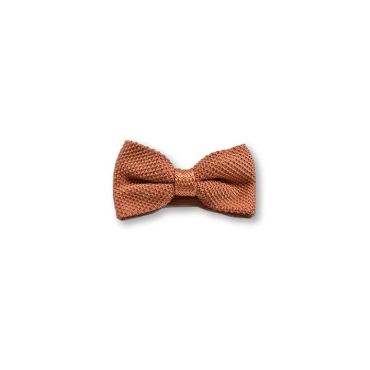 Rustic orange children's knitted bow tie, perfect for ages 2 to 11, featuring a classic design and adjustable strap.