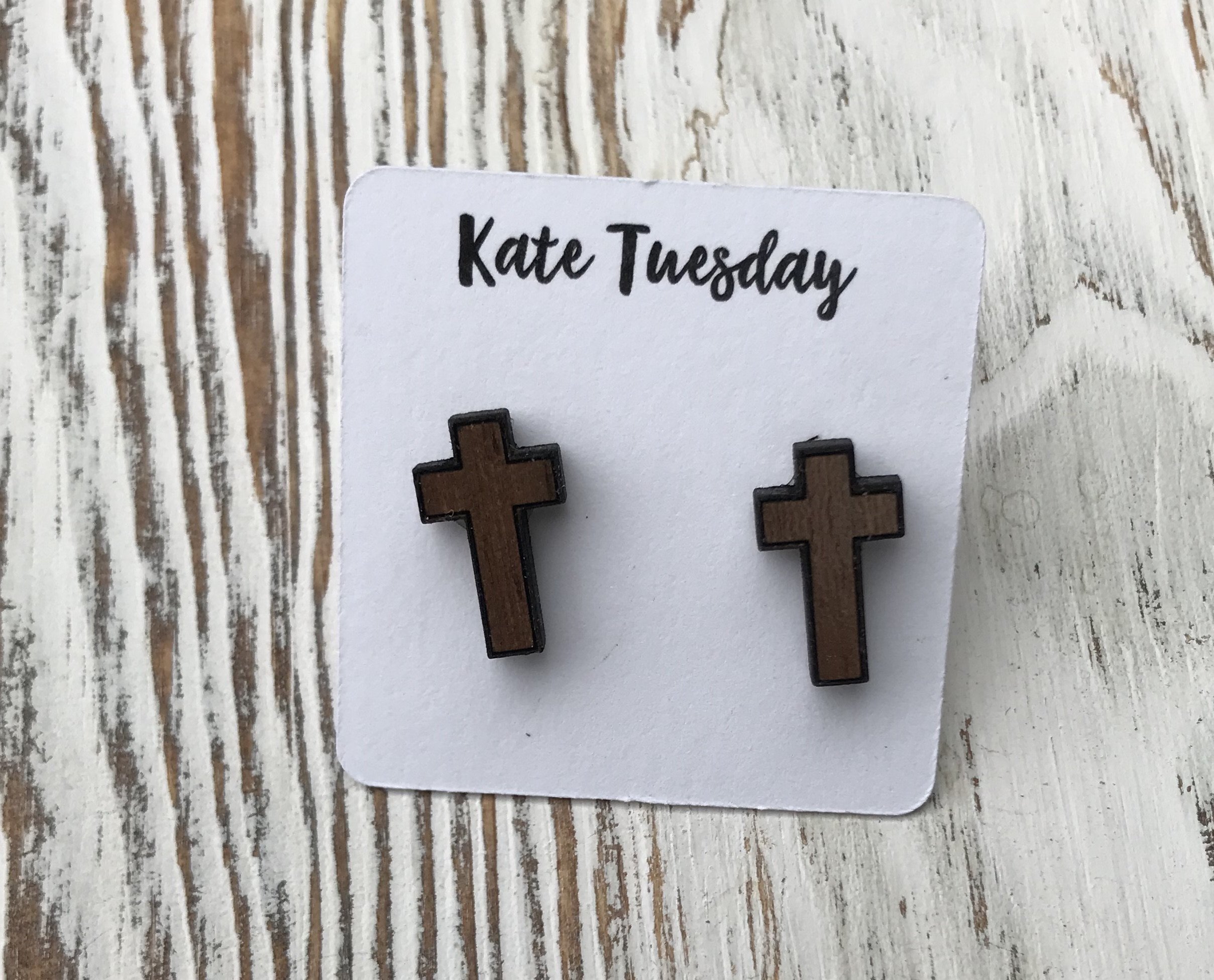 A pair of rustic wood cross stud earrings, showcasing their natural finish and unique design.