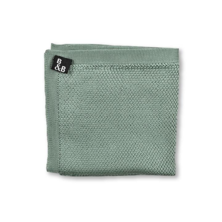 Sage green knitted pocket square displayed elegantly, showcasing its texture and color.